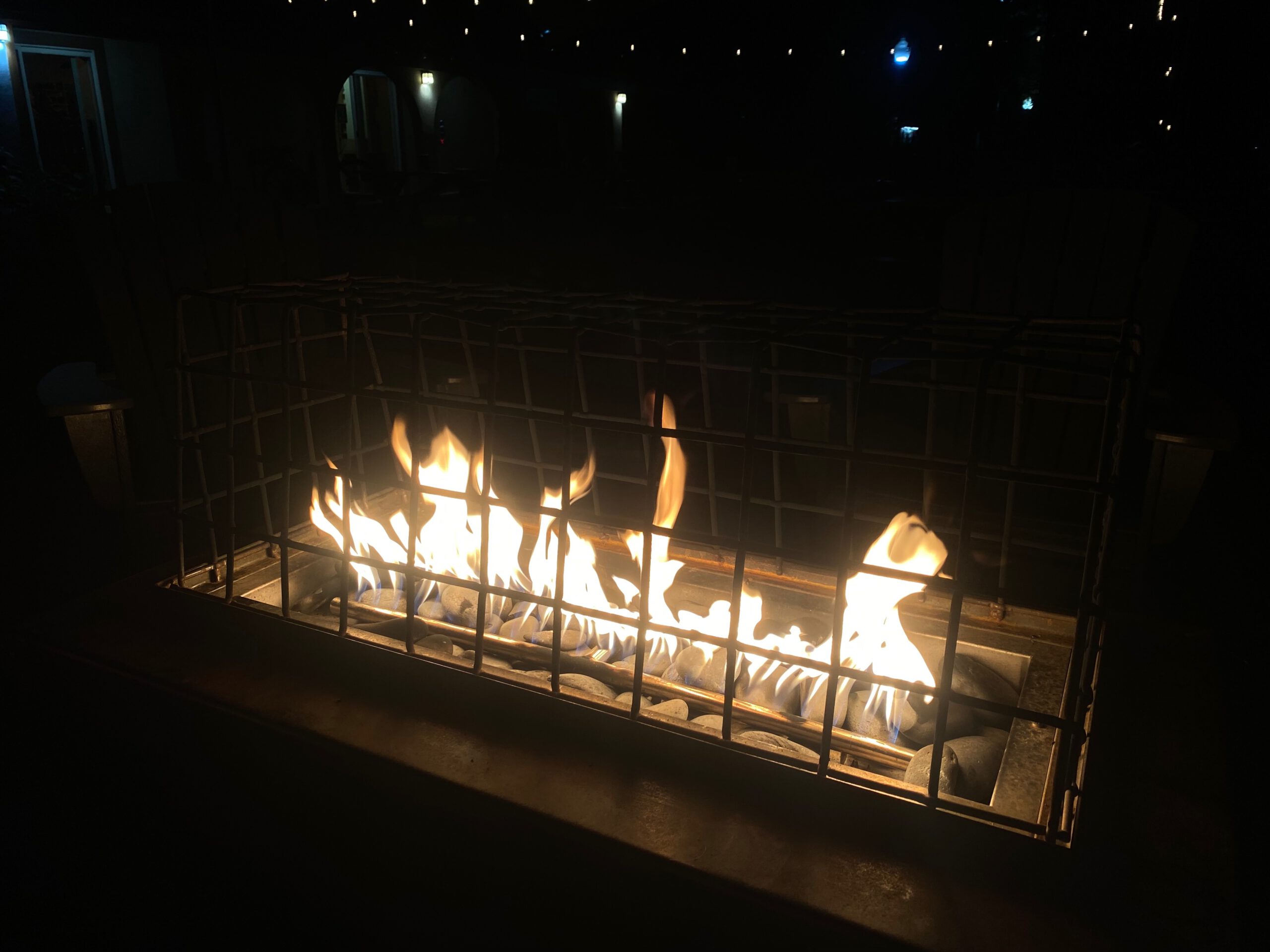 Outdoor fire pit glowing at Bear Belly Brewing Company in Kings Beach California, creating a warm and cozy evening atmosphere at a Lake Tahoe craft brewery