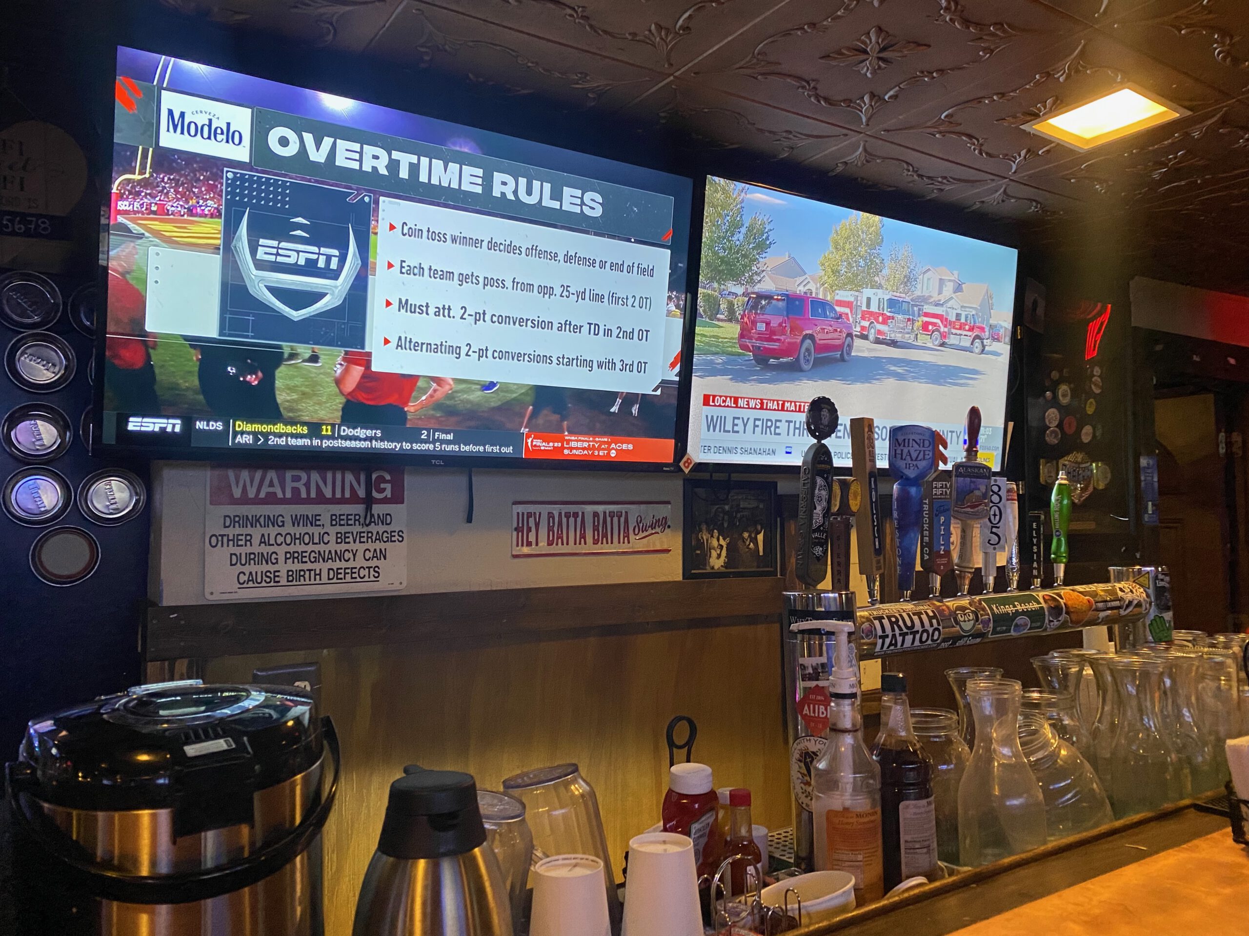 Sports bar interior at The Grid Bar and Grill Lake Tahoe with ESPN screens, draft beer taps and classic American bar decor