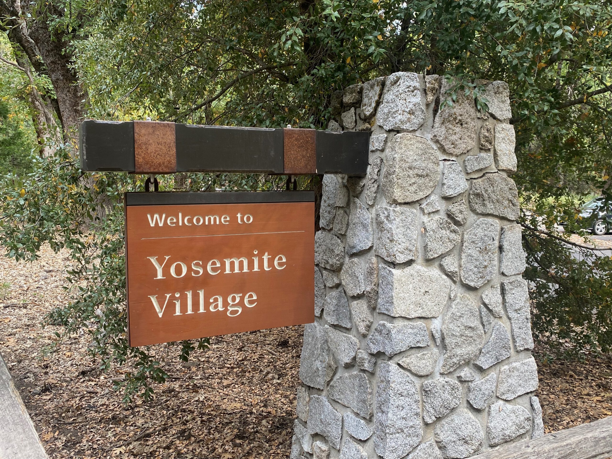 A sign from Yosemite Village, in the middle of Yosemite National Park. It marks the entrance of the village in the park.