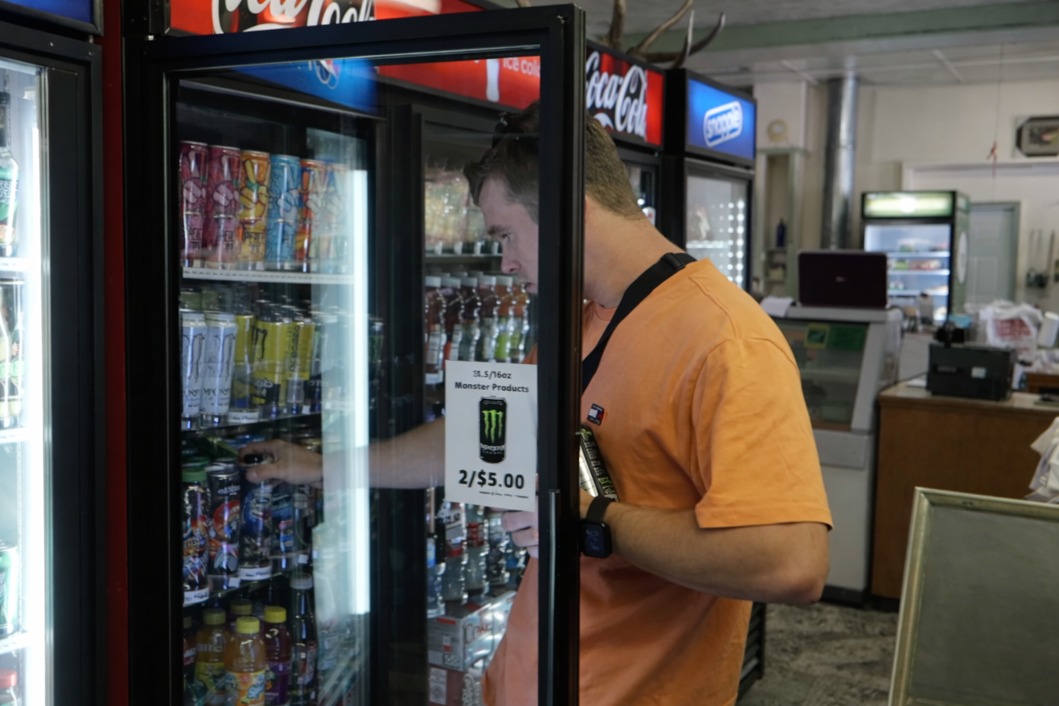 Interior of John Day River Trading Post in Kimberley Oregon, showing a traveler selecting drinks from the refrigerator. Peter Smit, peter010boy, is taking a Monster Energy Can