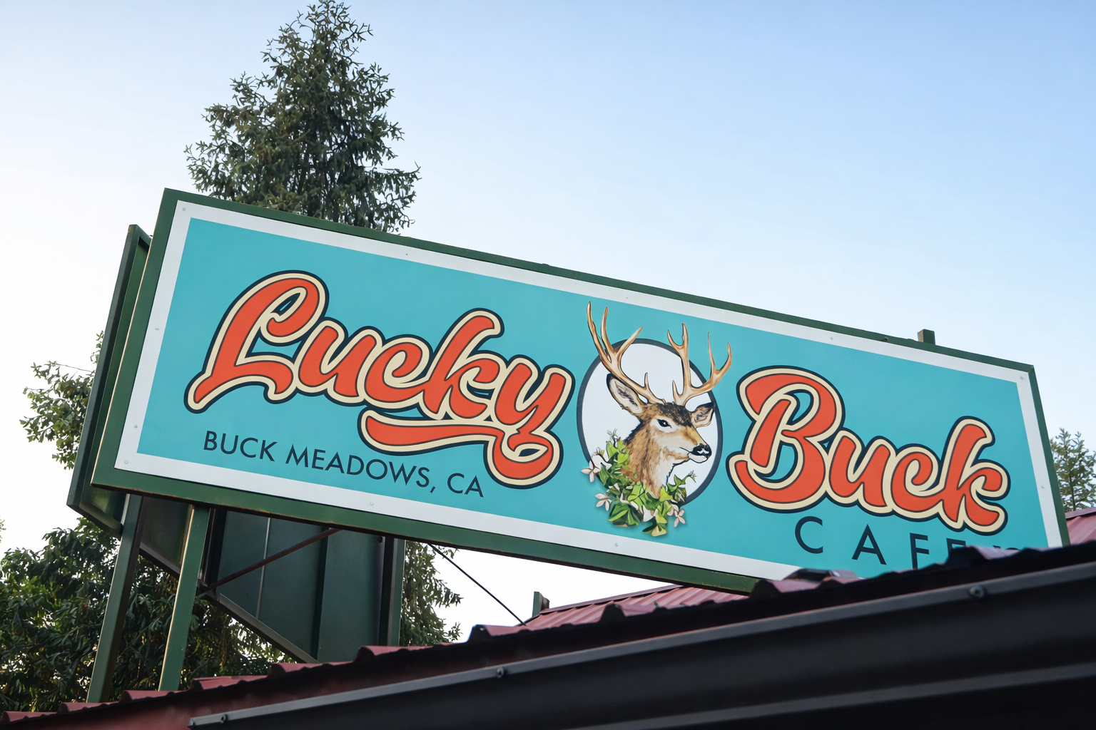 Lucky Buck Café roadside sign in Buck Meadows, California, featuring a turquoise vintage sign with a deer illustration along Highway 120 near Yosemite National Park.