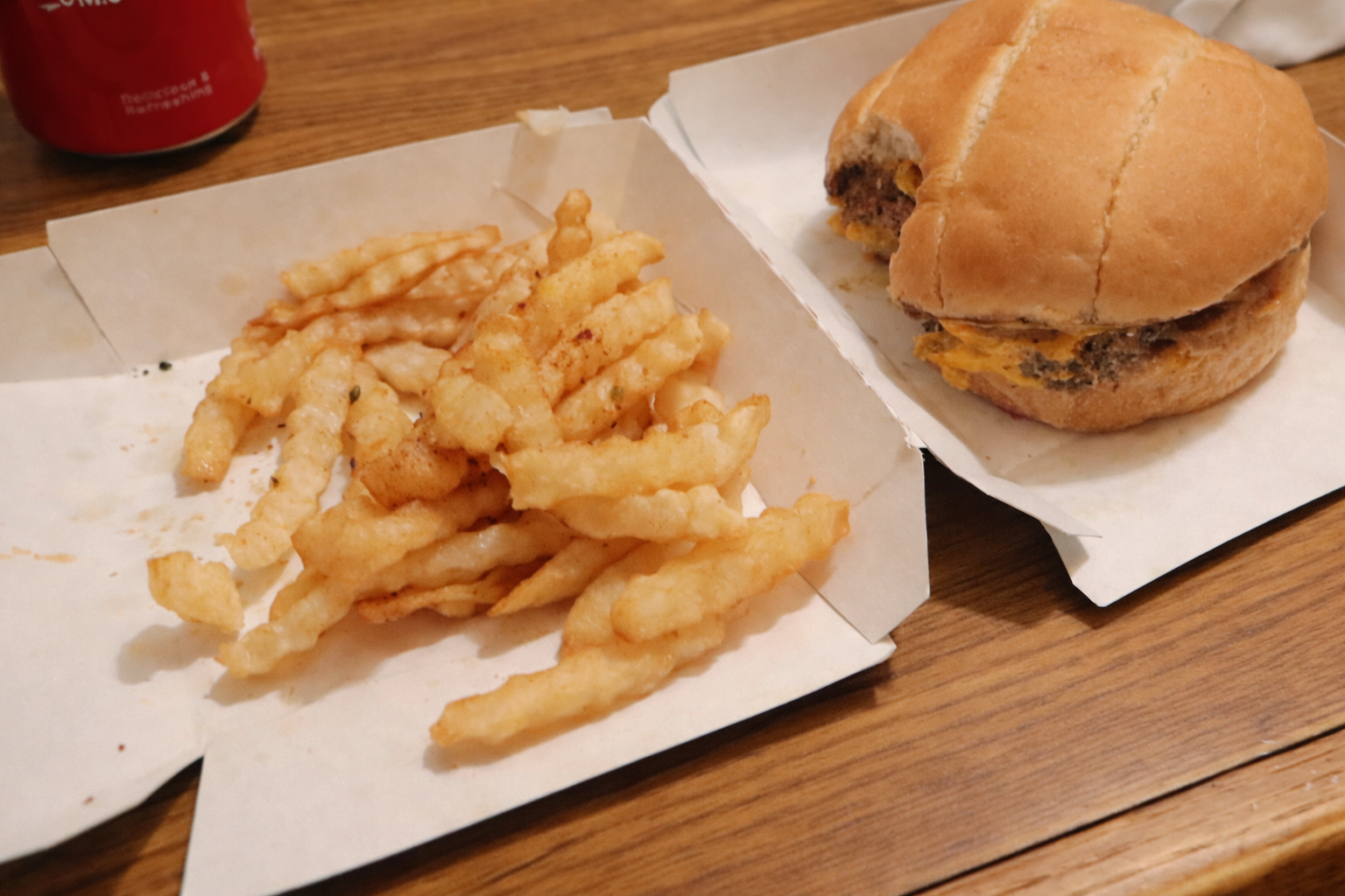 MrBeast Burger meal in San Francisco with a Beast Style burger and soft crinkle fries served on paper trays during an Uber Eats delivery.
