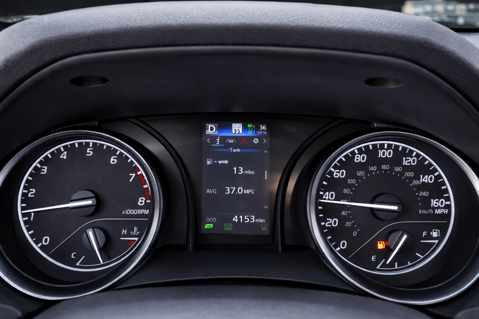Toyota Camry 2024 dashboard showing low fuel warning and remaining range while driving through rural Idaho, highlighting the need for a fuel stop at Exxon Carey Idaho.