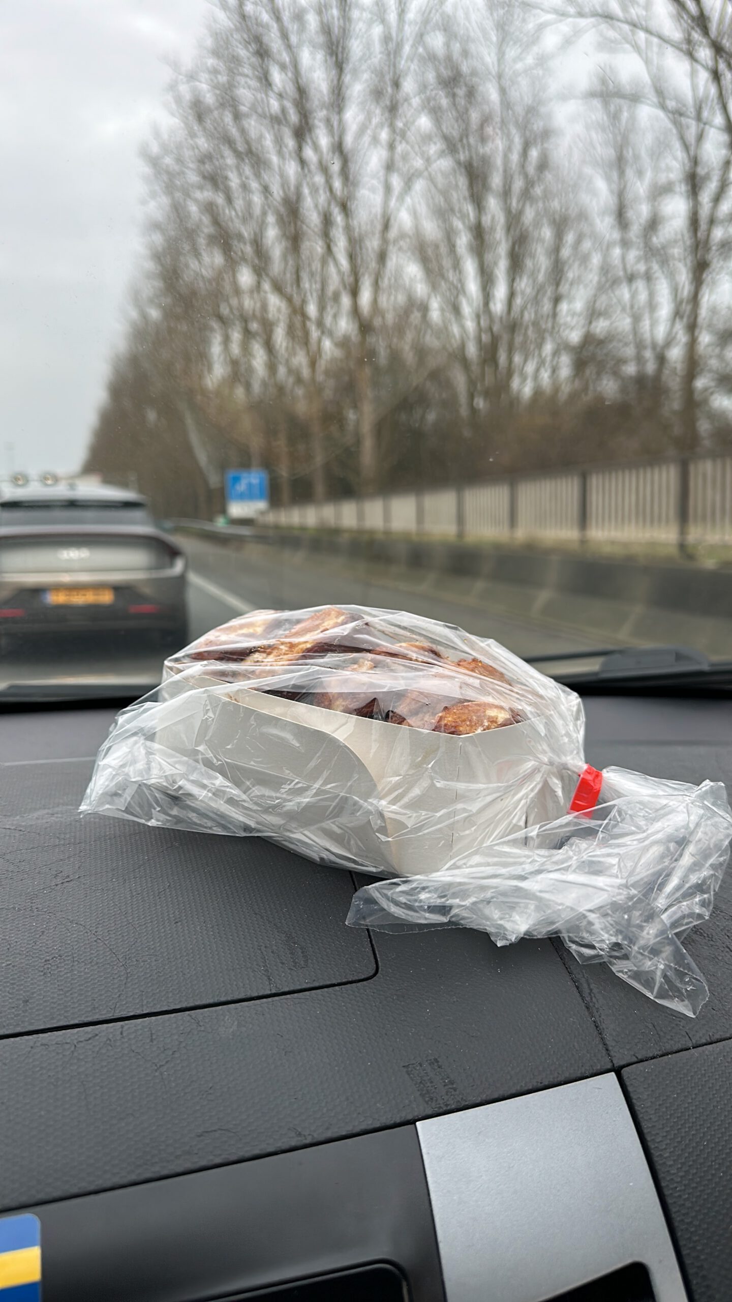 Bakkerij Sonnemans in Burgh Haamstede Zeeuwse bolussen in plastic bag on car dashboard during drive home after bakery visit