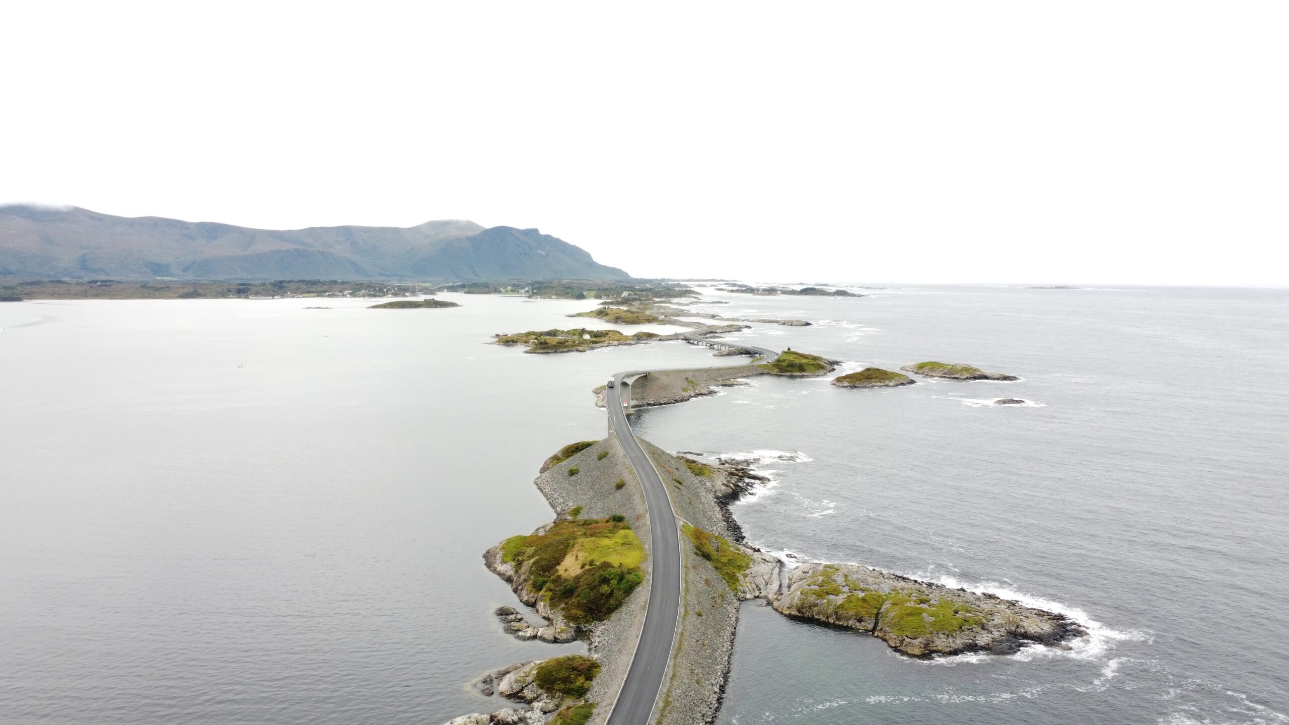 Atlantic Ocean Road Norway aerial view showing the iconic curved bridge and winding road across small islands in Møre og Romsdal