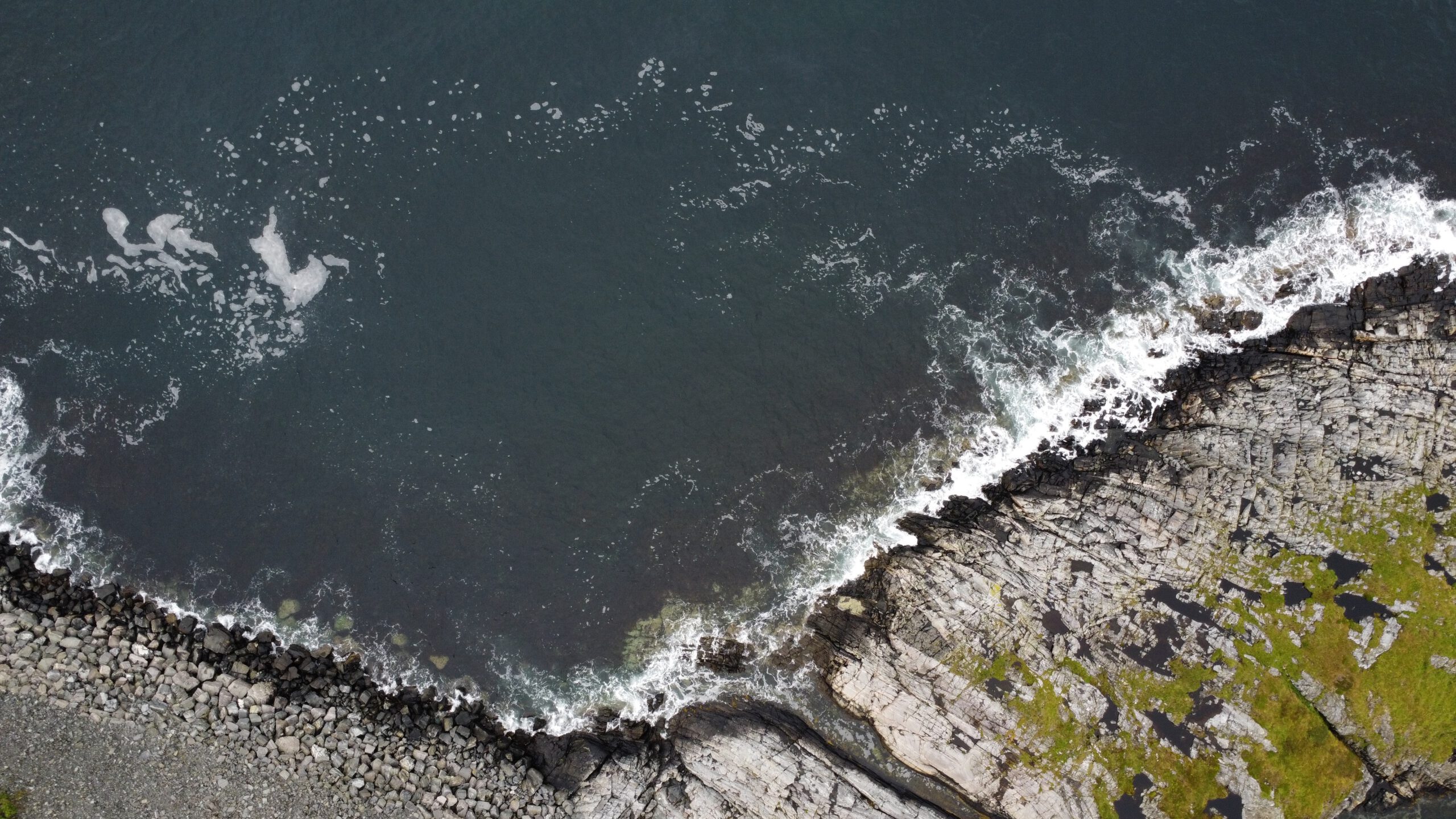 Top down aerial view of Atlantic Ocean Road Norway rocky coastline with Atlantic waves crashing against the cliffs in Møre og Romsdal