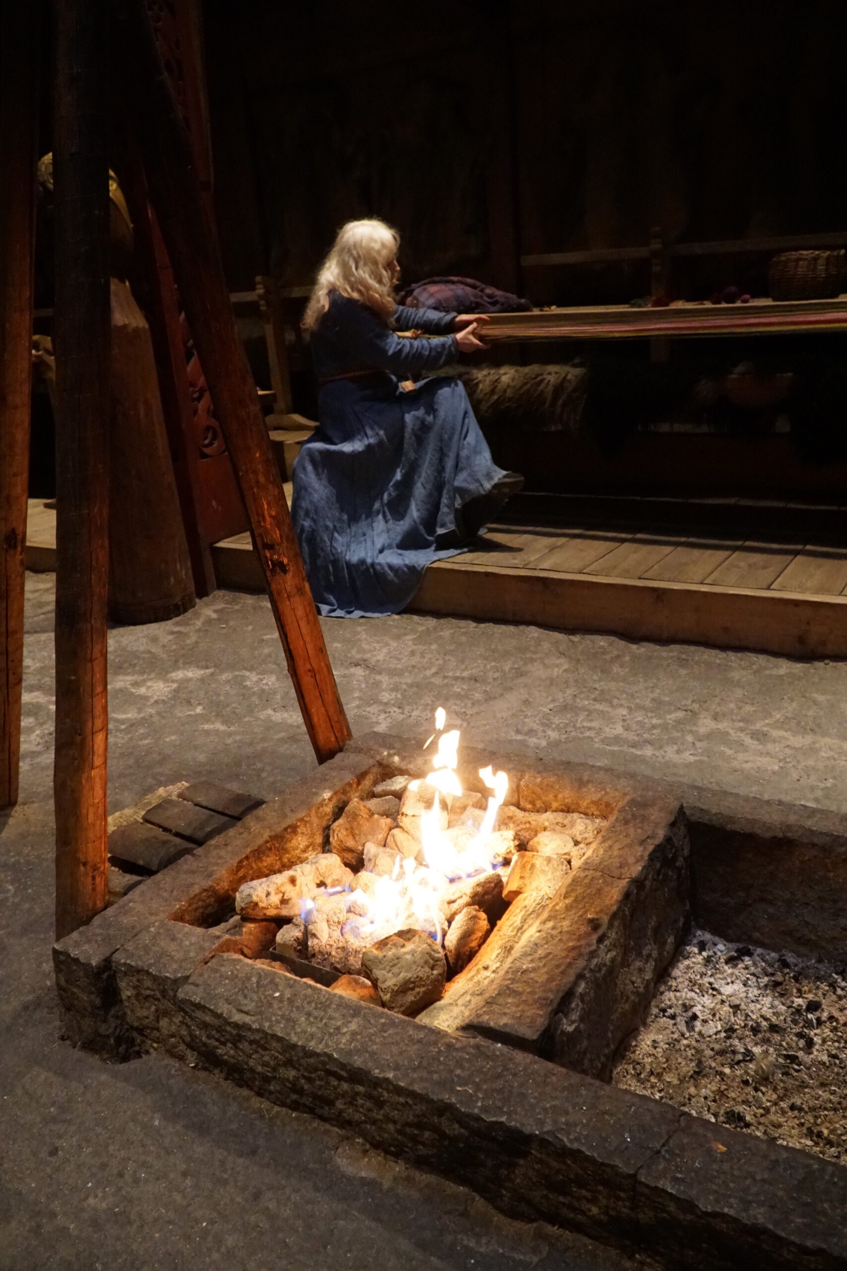Lofotr Viking Museum longhouse interior with open fire pit and historical Viking reenactment scene inside the Borg site on Vestvågøy, Lofoten Islands