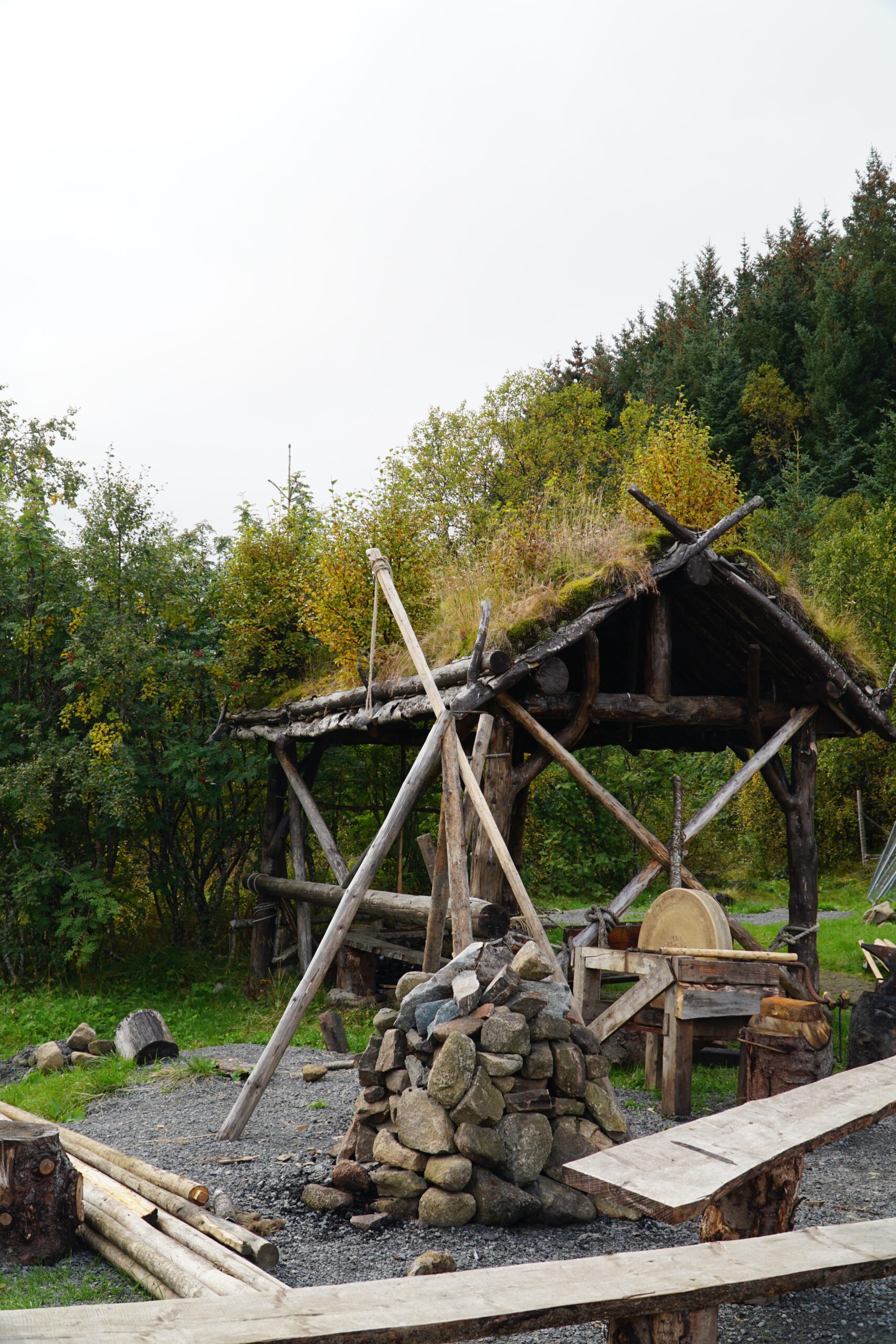 Lofotr Viking Museum reconstructed outdoor workshop with stone hearth, wooden structures and tools showing Viking daily life on the museum grounds in Borg, Lofoten Islands