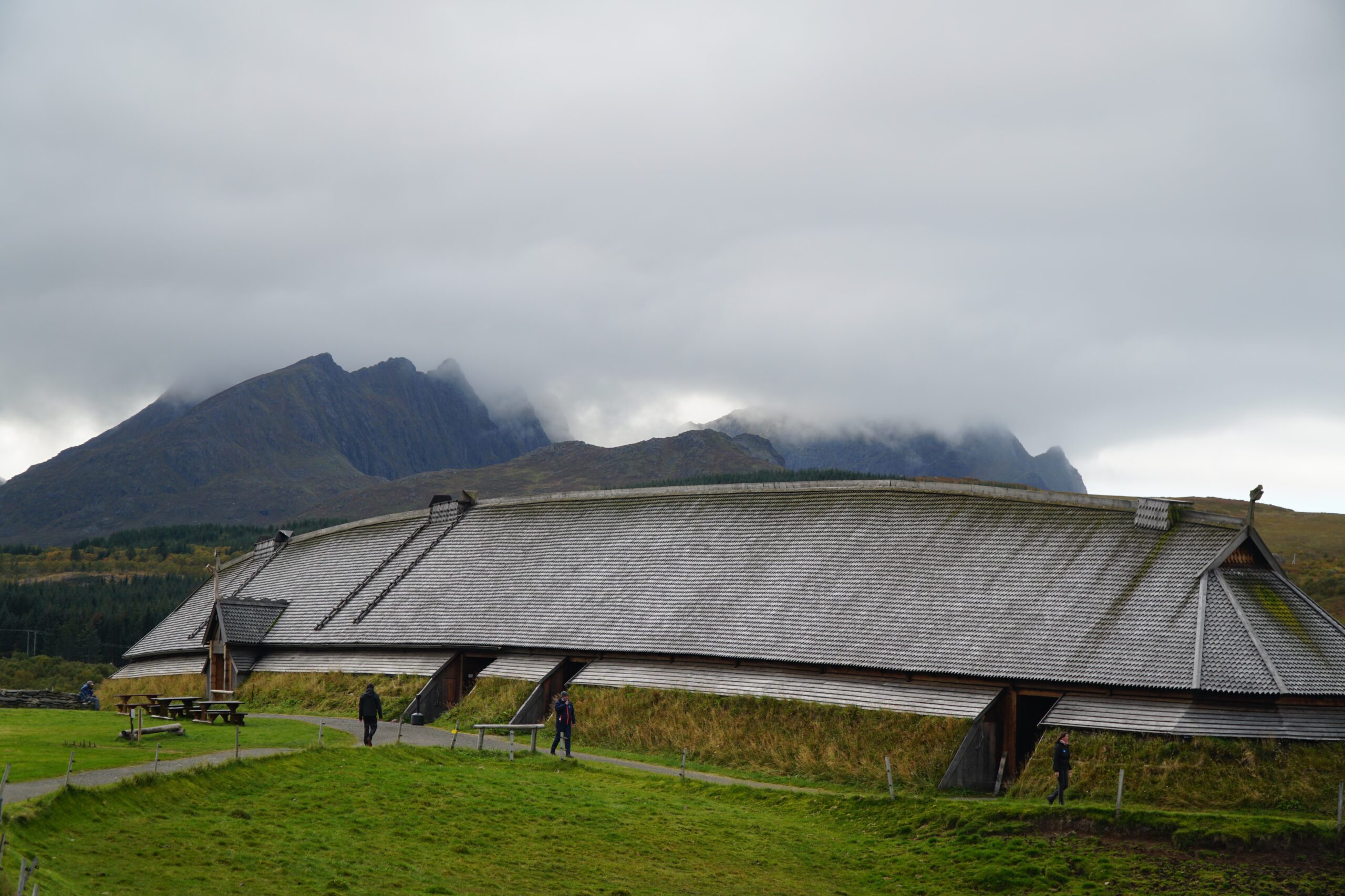 Lofotr Viking Museum longhouse in Borg on the Lofoten Islands, iconic reconstructed Viking longhouse set against misty mountains in northern Norway