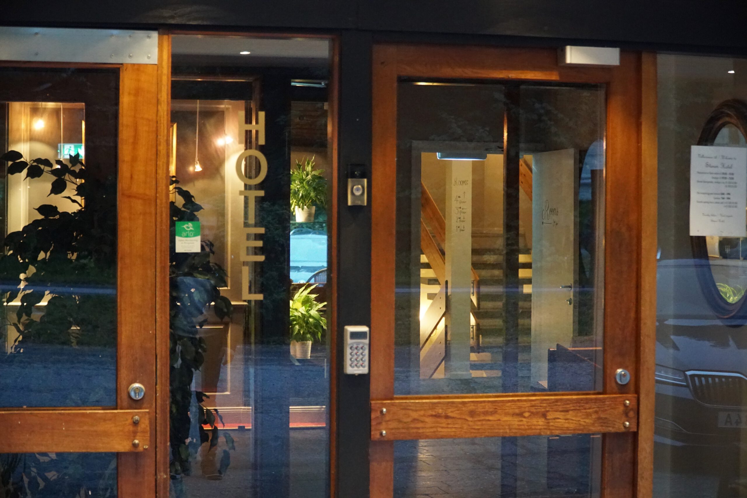 Støren Hotel Norway review main entrance at Engan 25 in Trøndelag, showing the wooden hotel doors, keypad access system and interior staircase view