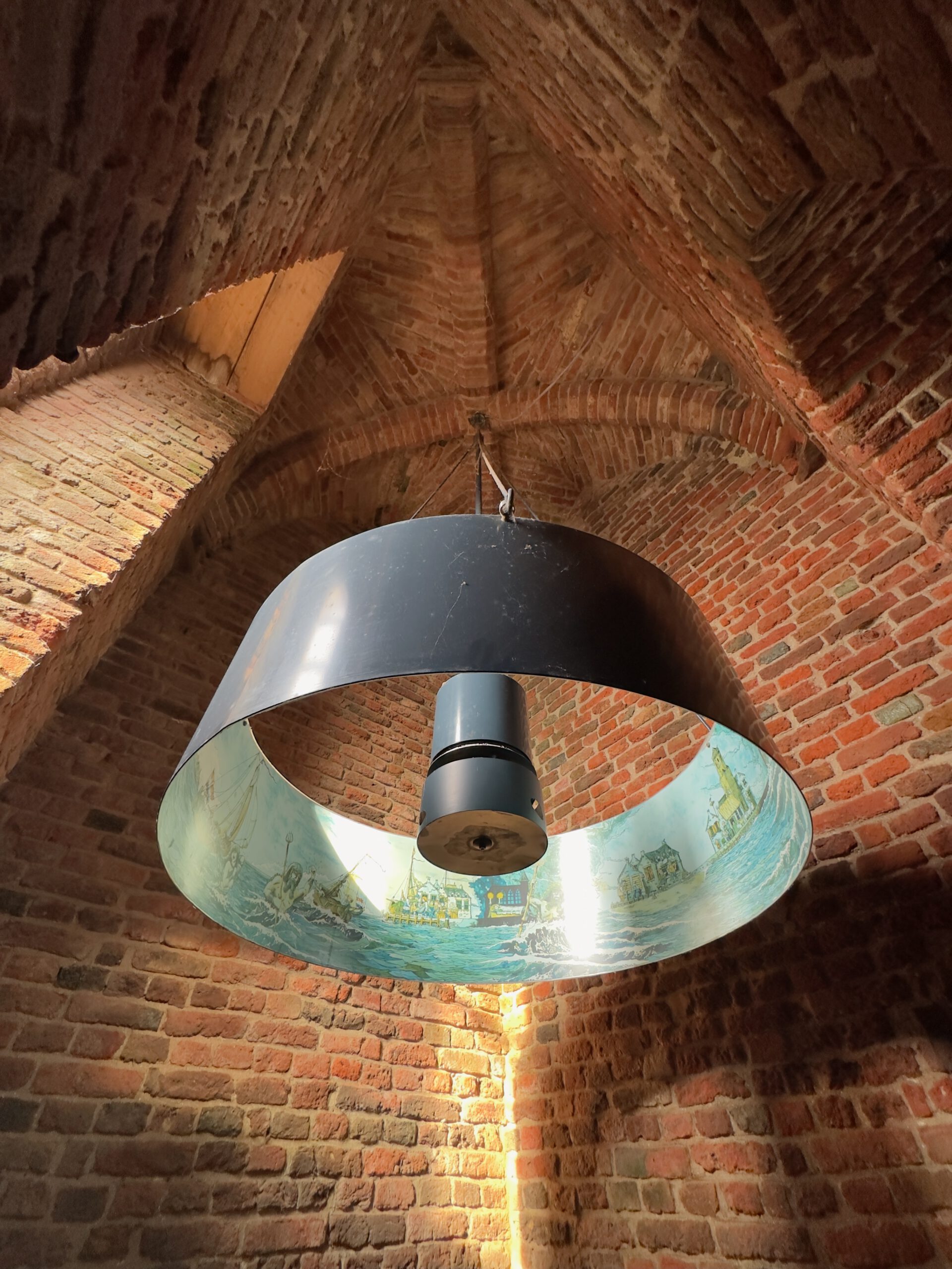 Plompe Toren Koudekerke interior brick vaulted ceiling with circular maritime storytelling installation about the drowned village and mermaid legend