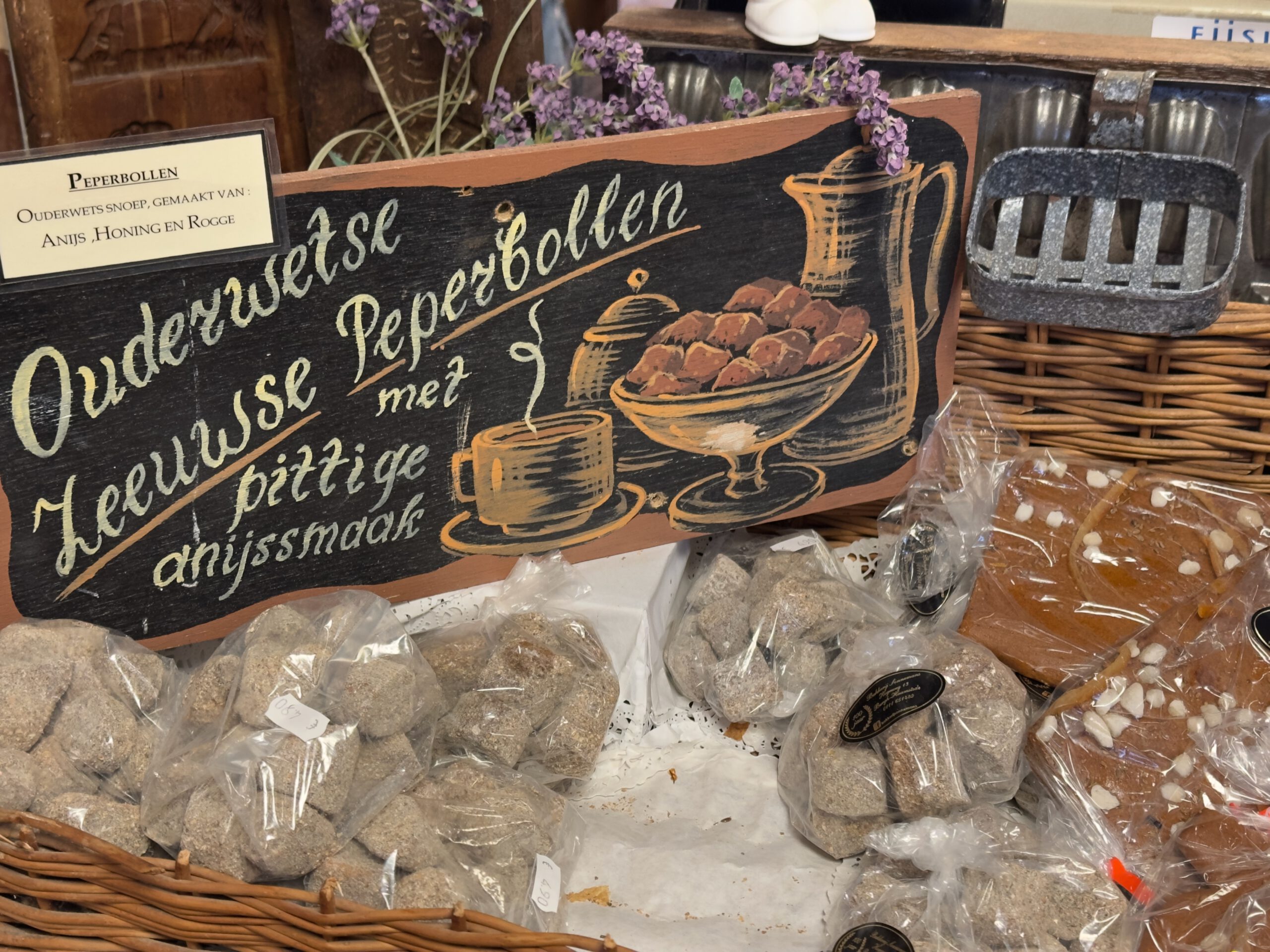 Bakkerij Sonnemans in Burgh Haamstede display with traditional Oudewetse Zeeuwse peperbollen, packaged sweets and handwritten chalkboard sign describing anise flavor