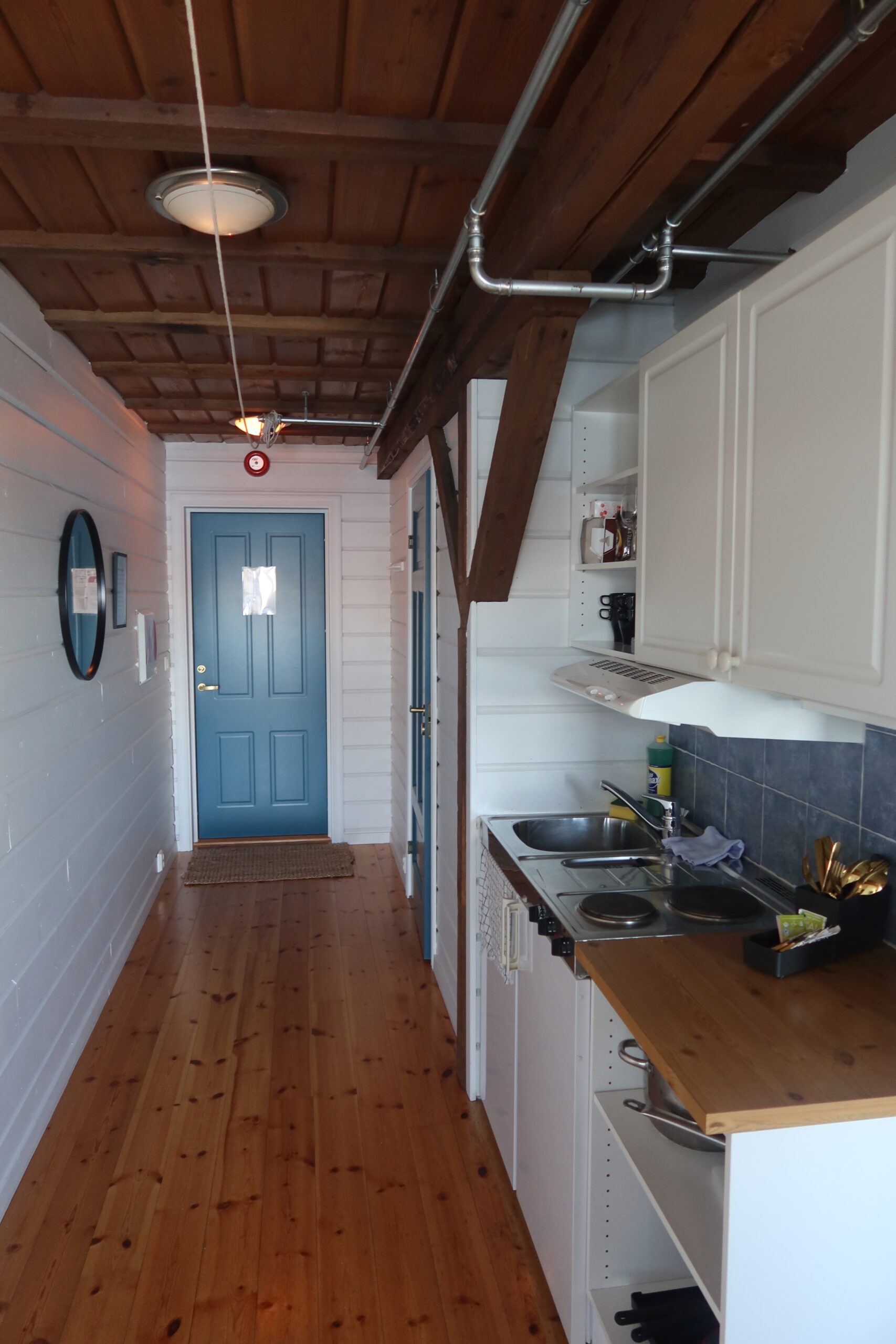 Compact kitchen and entrance hallway at Lødingen waterfront hotel Norway, small kitchenette inside a traditional Norwegian coastal hotel room