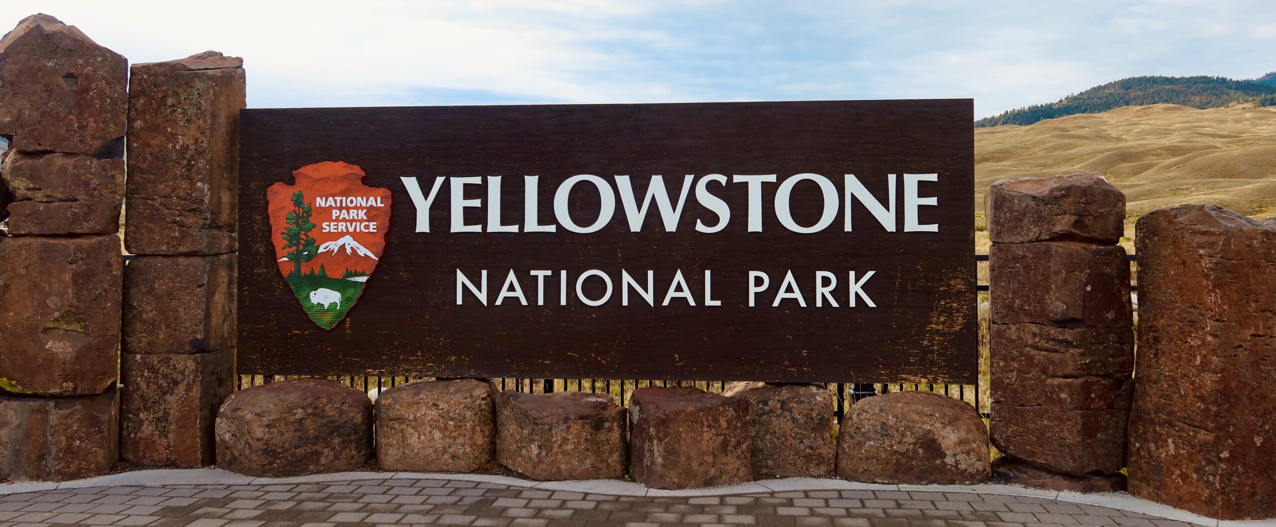 Wildlife in Yellowstone NP begins at the iconic Yellowstone National Park entrance sign near the Montana gateway