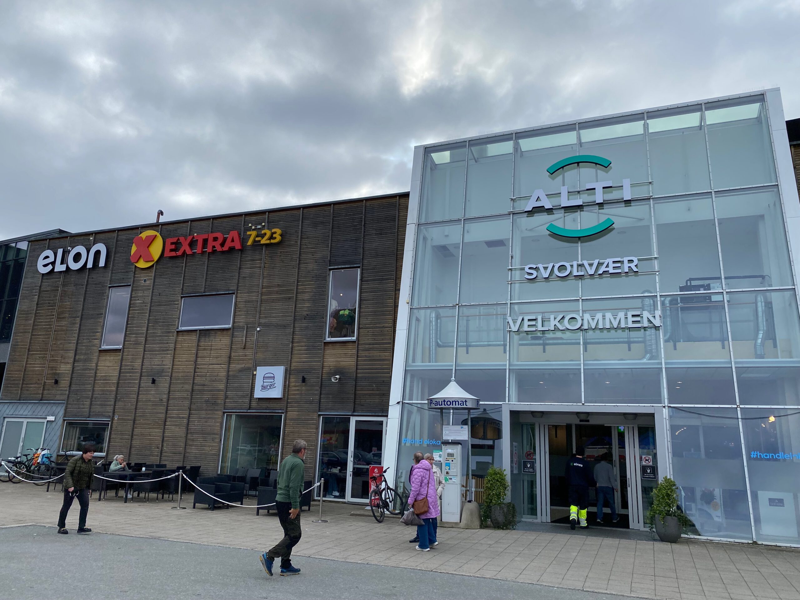 Main entrance of Alti Svolvær Shopping Mall with glass facade wooden exterior and welcoming signage in Svolvær