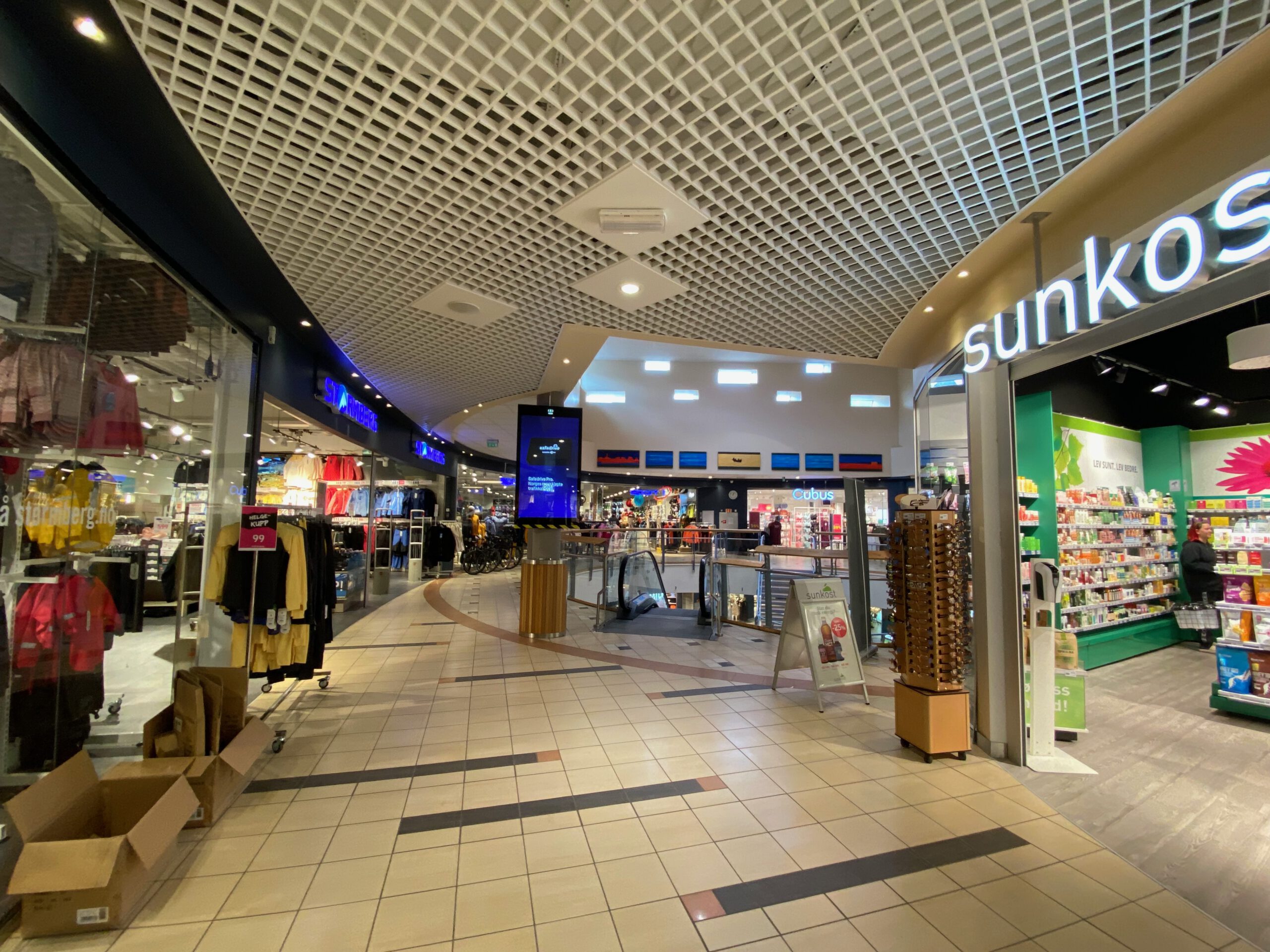 Interior view of Alti Svolvær Shopping Mall showing modern shopping corridor with stores escalators and retail atmosphere