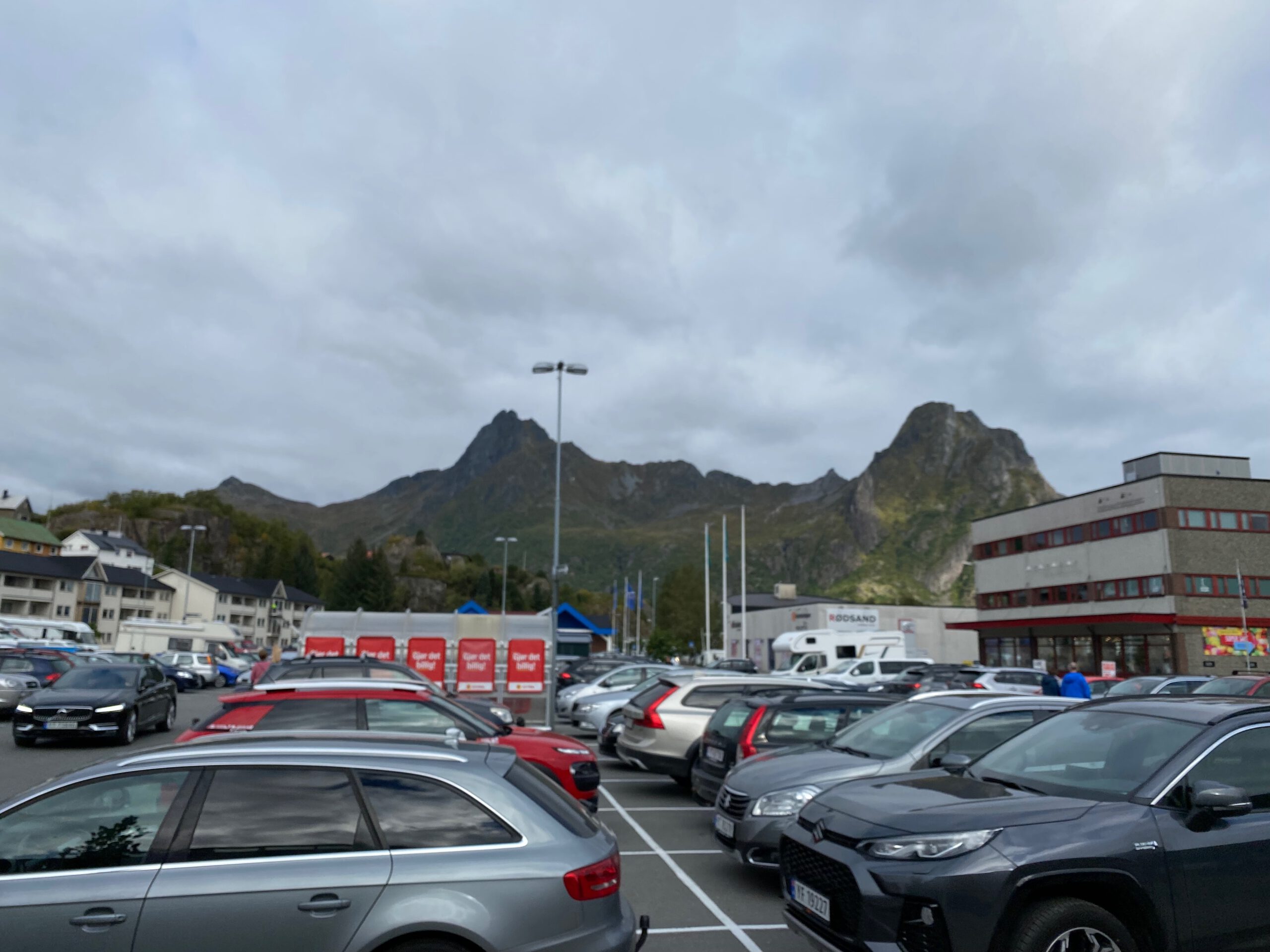 Alti Svolvær Shopping Mall parking area with free parking spaces and dramatic Lofoten mountains in Svolvær Norway