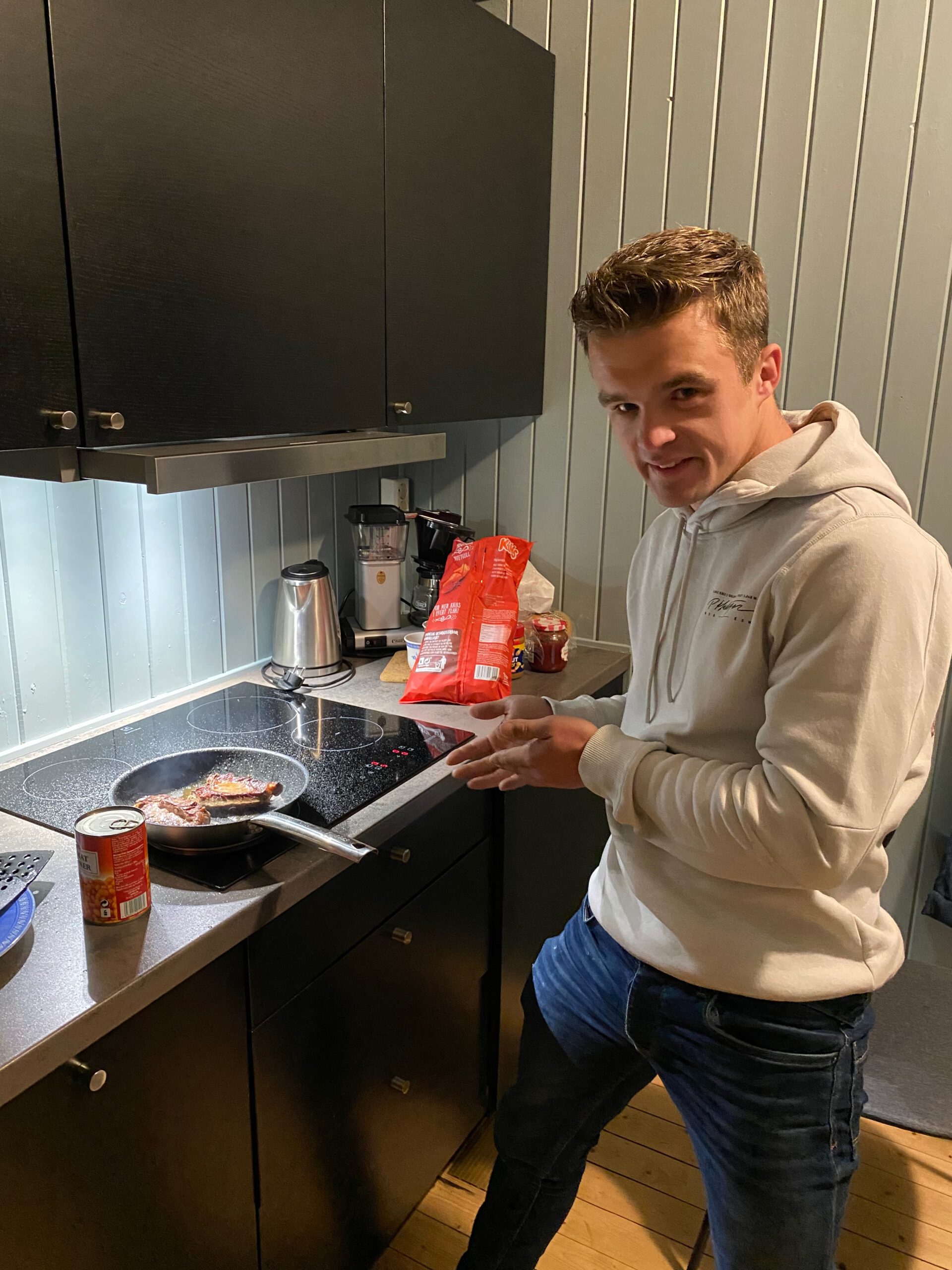 The Tide Fisherman Cabins Lofoten, relaxed evening cooking inside the fisherman cabin with simple comfort food after a long day on the Lofoten Islands, Peter Smit cooking