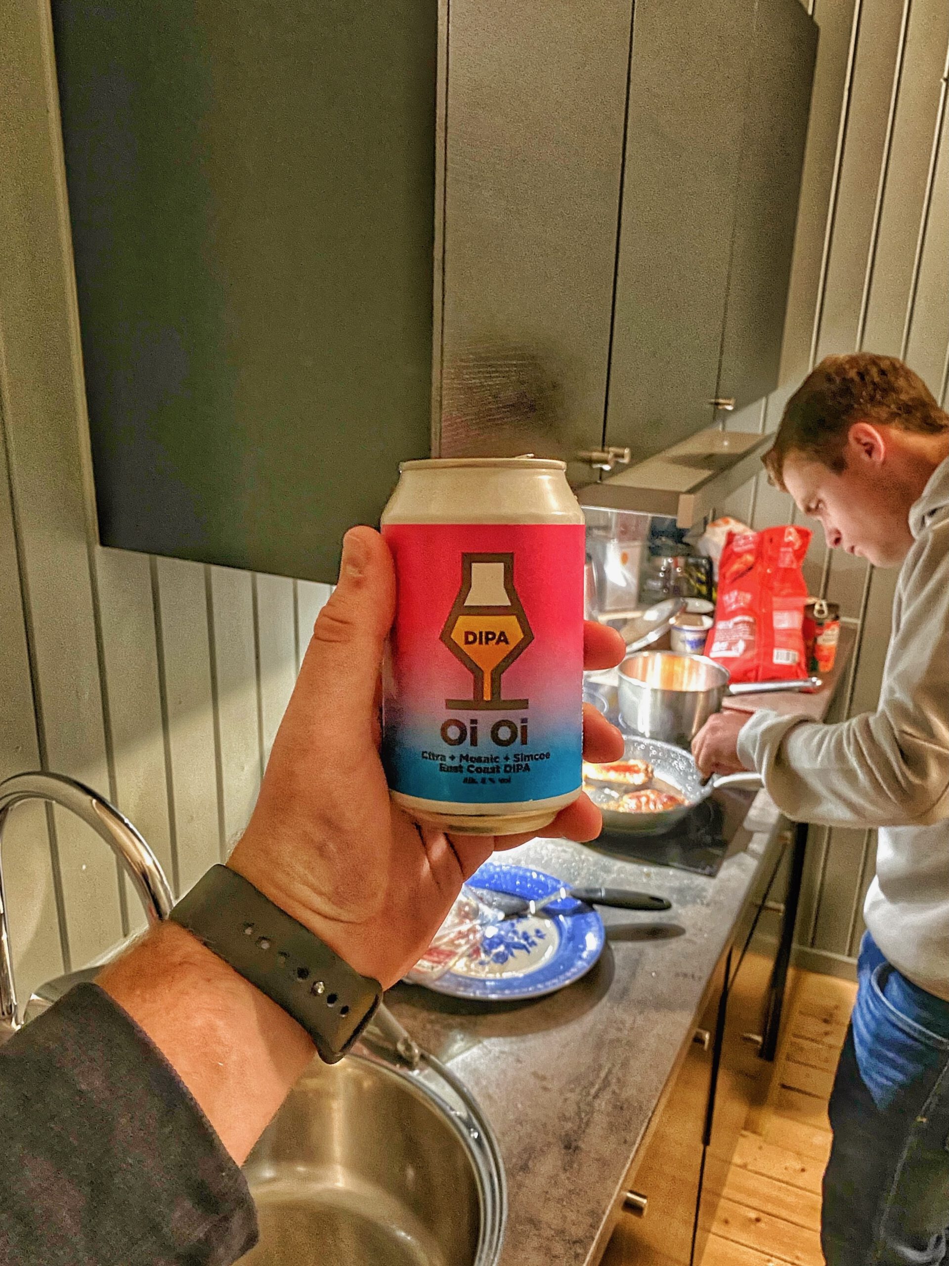 The Tide Fisherman Cabins Lofoten, casual cabin cooking moment with local beer and dinner preparation in the fully equipped kitchen