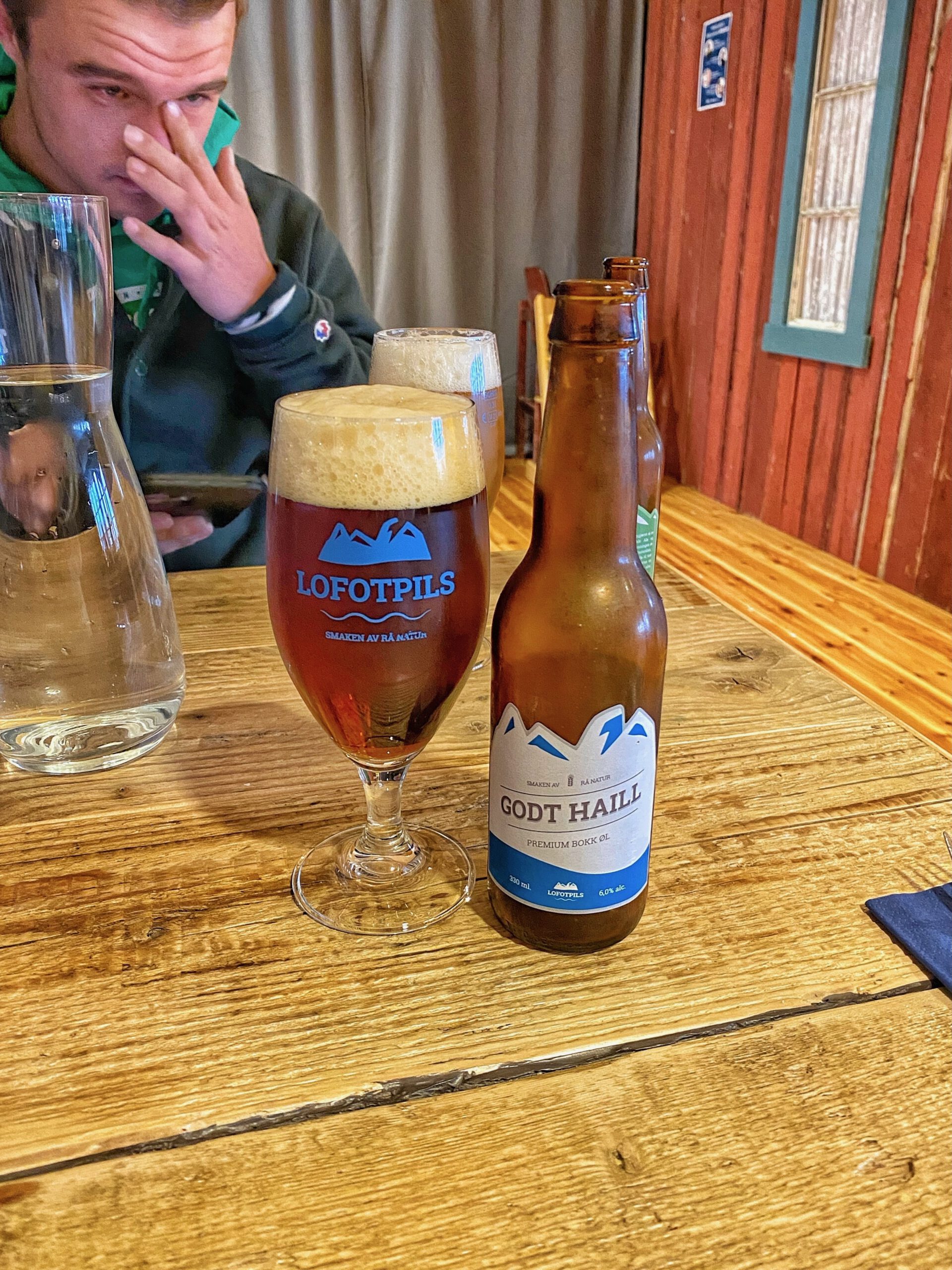 Å Rorbuer Lofoten restaurant table with Lofotpils draft beer and Godt Haill bottled beer from Lofoten Brewery during dinner in Å i Lofoten