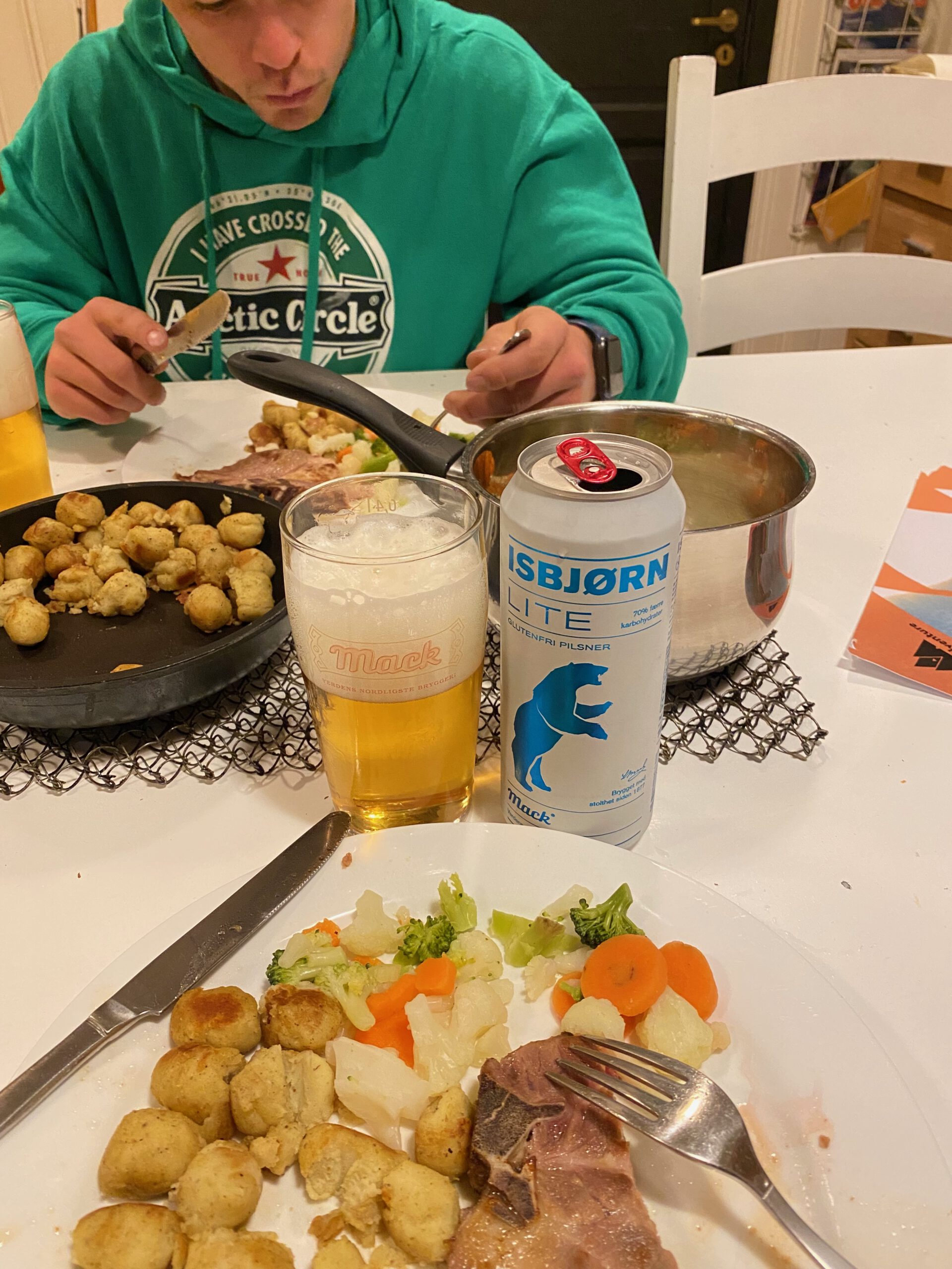 Gulbrakka Basecamp Glomfjord shared kitchen dinner, homemade meal with grilled steak, fried potatoes, mixed vegetables and a glass of Mack beer and Isbjørn Lite pilsner during an evening meal