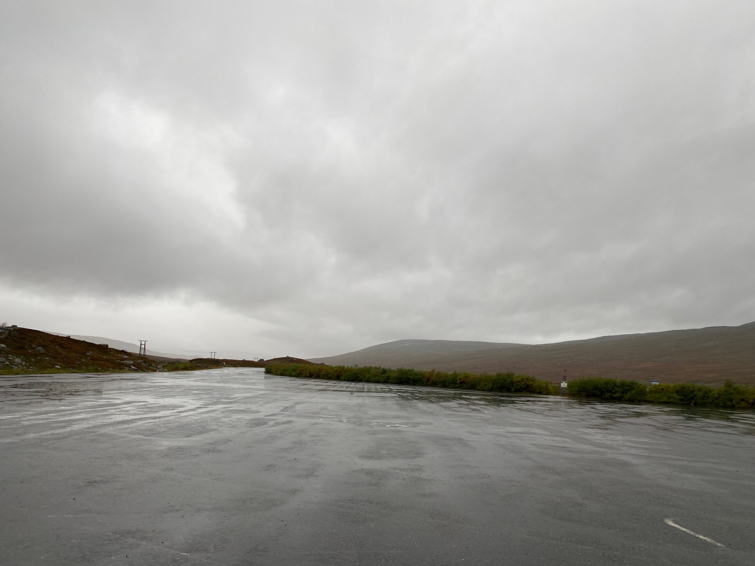 Parking area at the Arctic Circle Centre Norway in Saltfjellet, wet road conditions along the E6 under Arctic weather