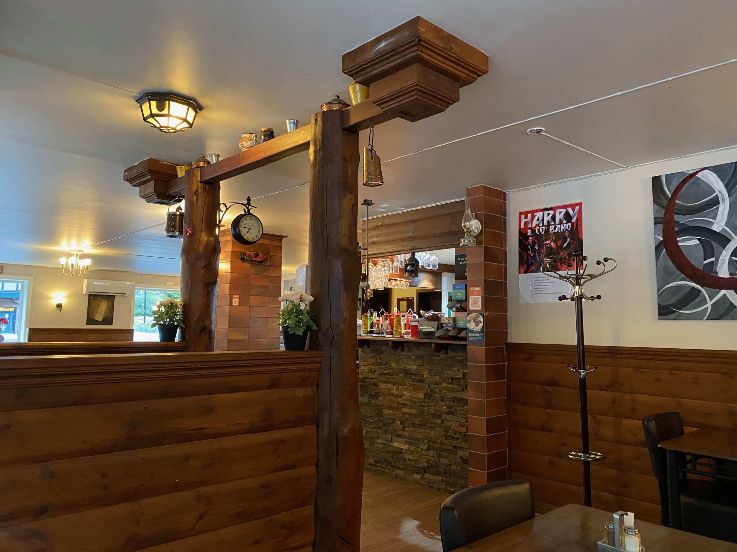 Interior of Torino Restaurant Støren in Norway, cozy wooden dining area with bar and warm lighting near Støren Hotel