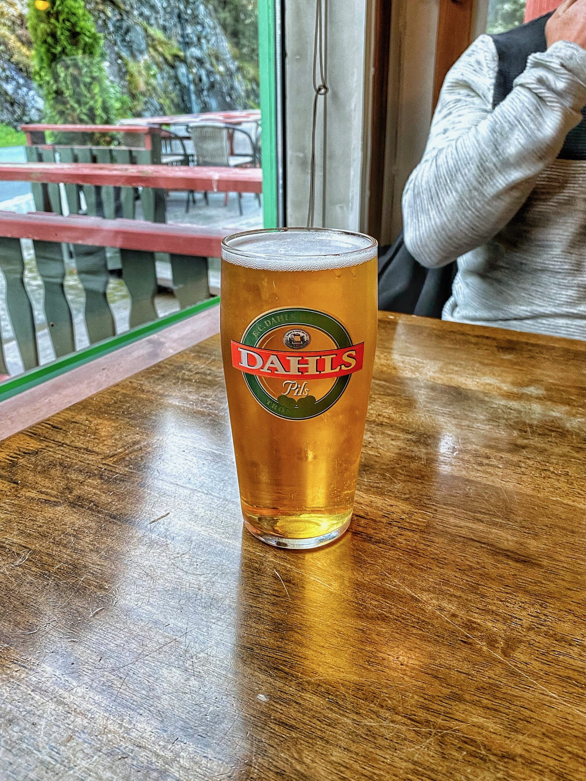 Dahls Pils from E.C. Dahls Bryggeri served at Torino Restaurant Støren in Støren Norway, cold Norwegian beer on wooden restaurant table