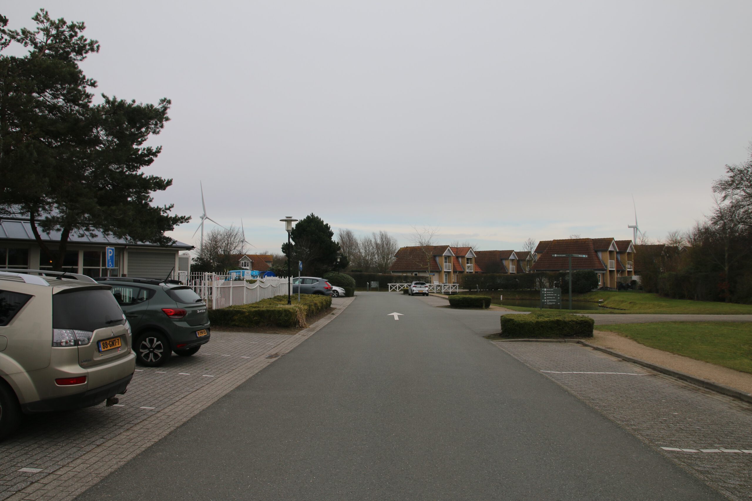 Landal Noordzee Résidence De Banjaard central park road and parking area in Kamperland, Zeeland, holiday homes and wind turbines visible near the North Sea coast