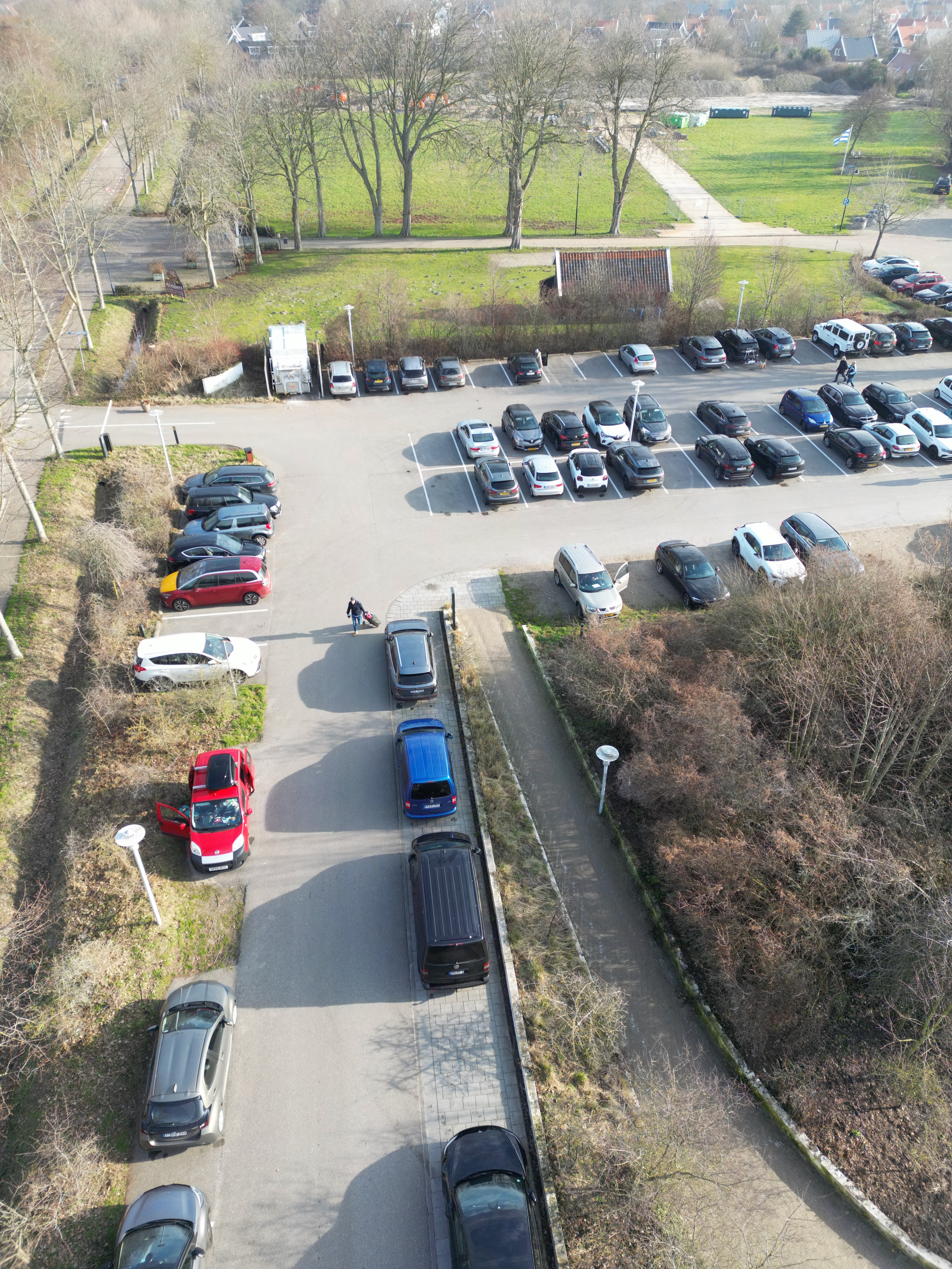 Grand Hotel Ter Duin review aerial view of the hotel parking area in Burgh Haamstede with multiple cars, surrounding greenery, and nearby countryside