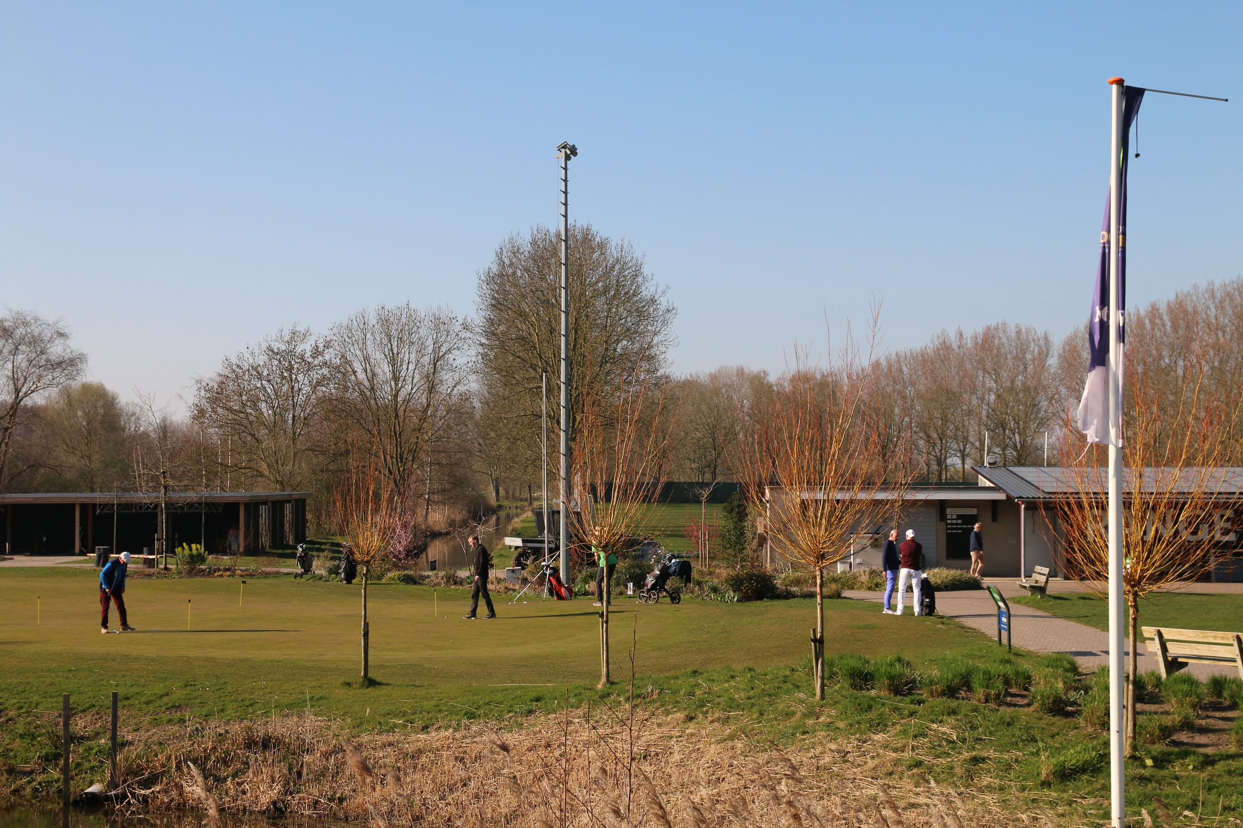 Golfclub Zeegersloot practice green and clubhouse area in Alphen aan den Rijn on a sunny day