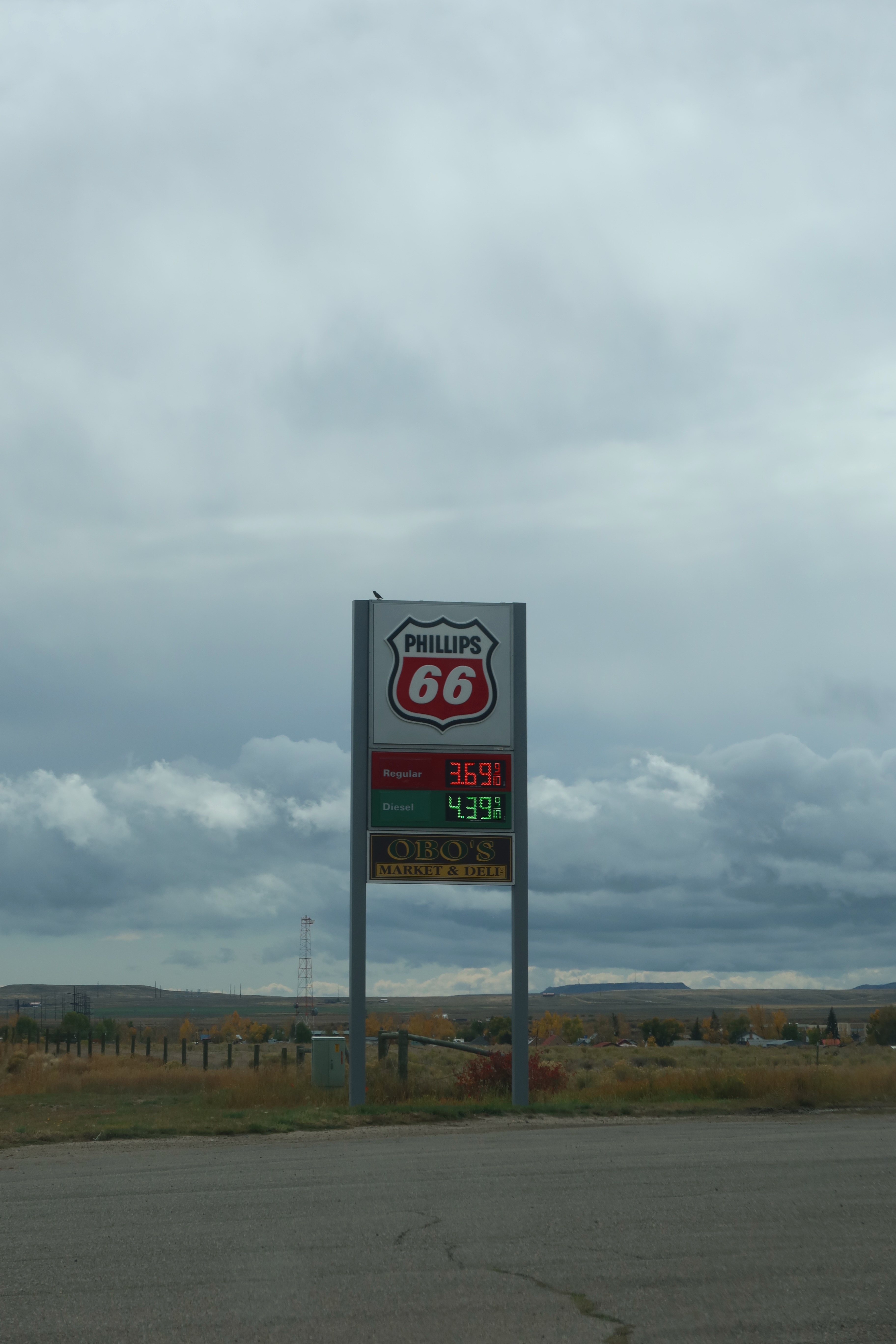 Gas stations in America, Phillips 66 fuel price sign above a quiet rural roadside stop under cloudy skies