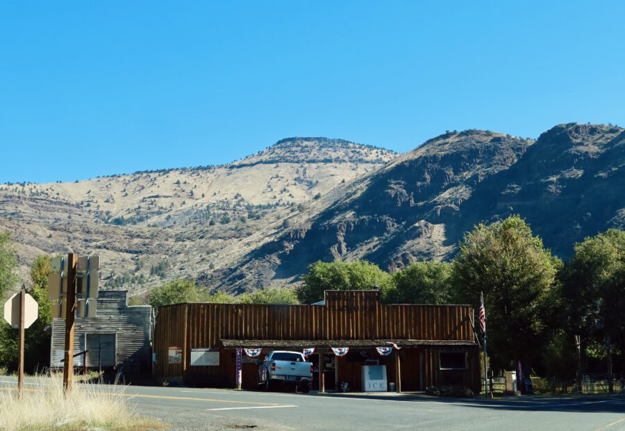 Gas stations in America, John Day River Trading Post in Kimberly Oregon with ice bucket, pickup truck, and dry mountain landscape