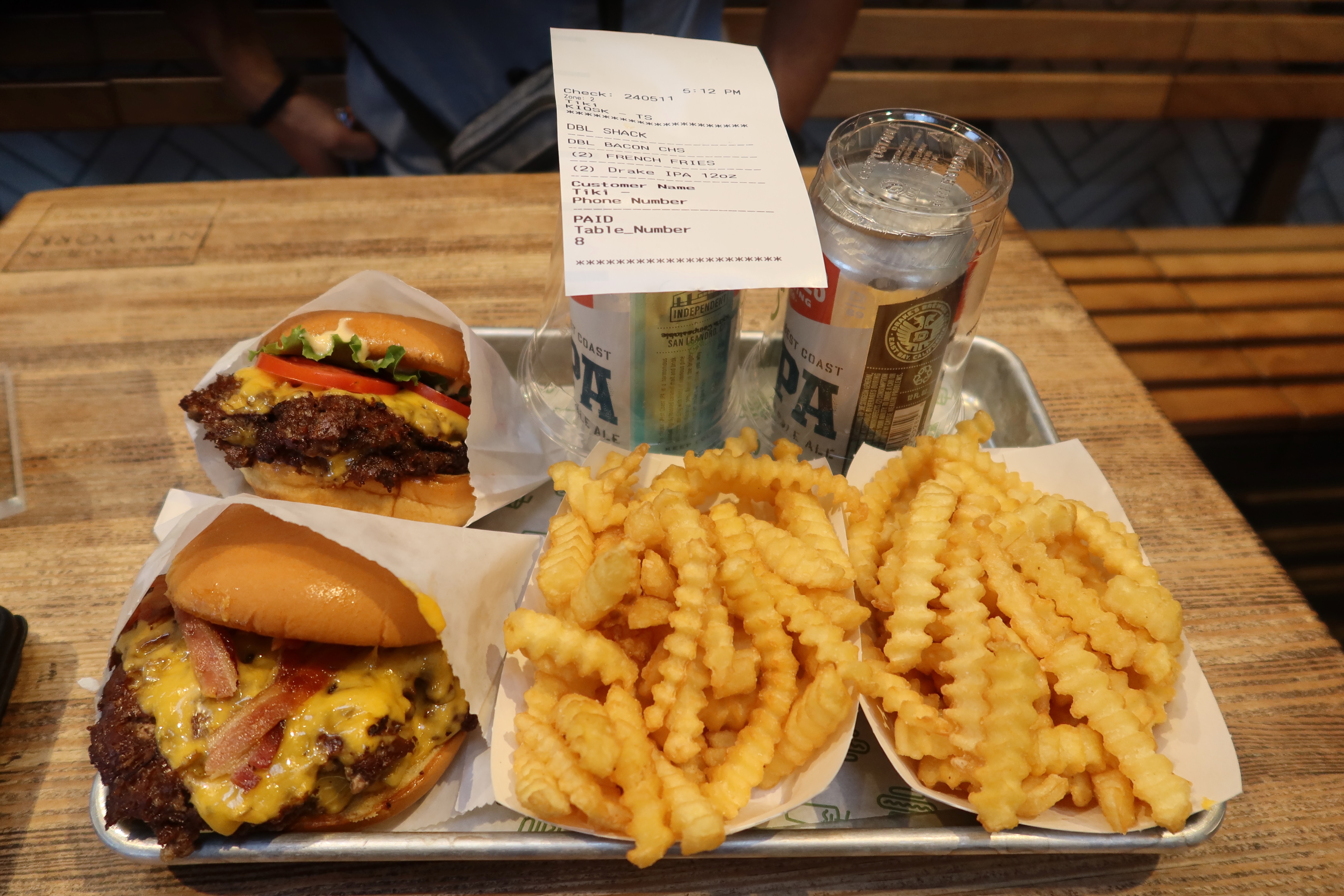 Best food in San Francisco featuring burgers, crinkle fries, canned IPA, and water on a casual restaurant tray