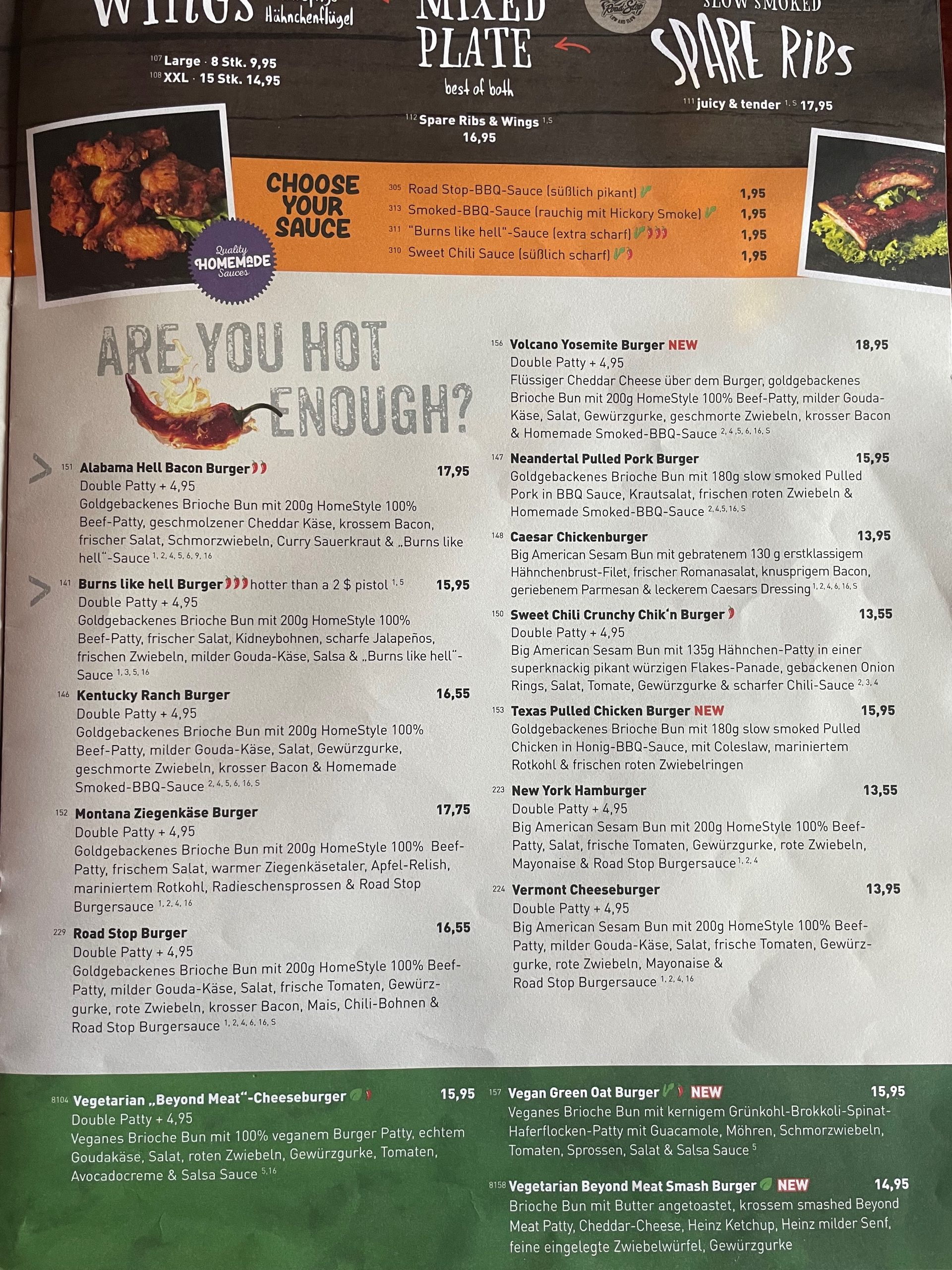 Road Stop Wuppertal menu with chicken wings, spare ribs, BBQ sauces, hot burgers, pulled pork burgers, and vegetarian burger options.