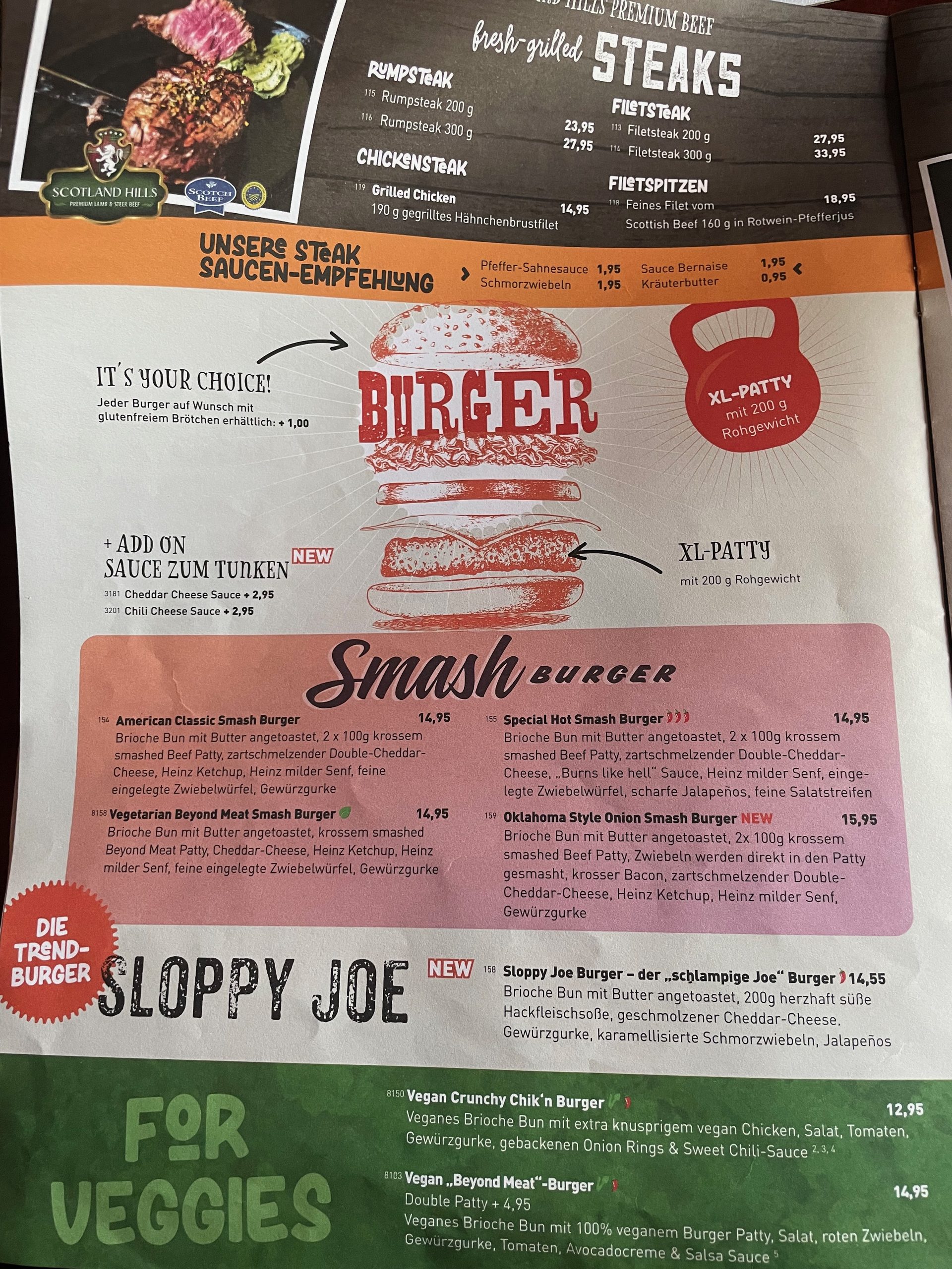 Road Stop Wuppertal menu with steak options, smash burgers, Sloppy Joe burgers, vegan burgers, and American style food choices.