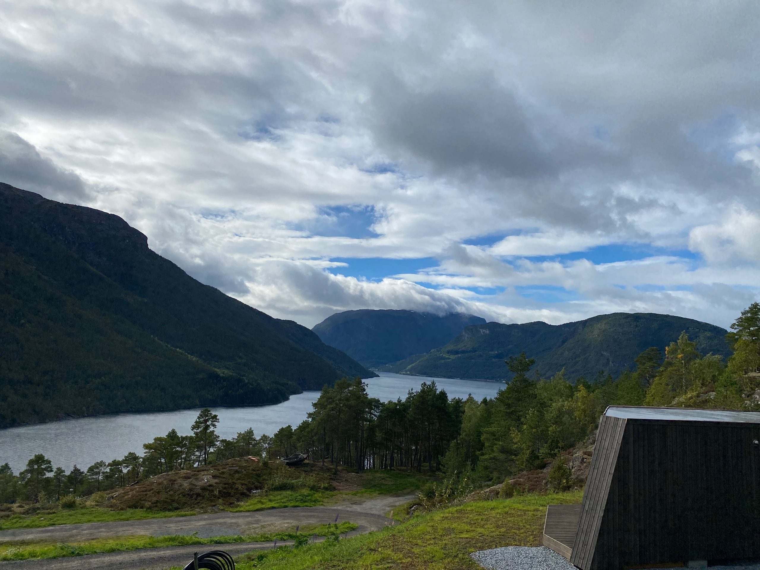 Scenic fjord and mountain view from Sogndal Fjordpanorama during a Sogndal Fjordpanorama Review in Norway, with a modern cabin in the foreground