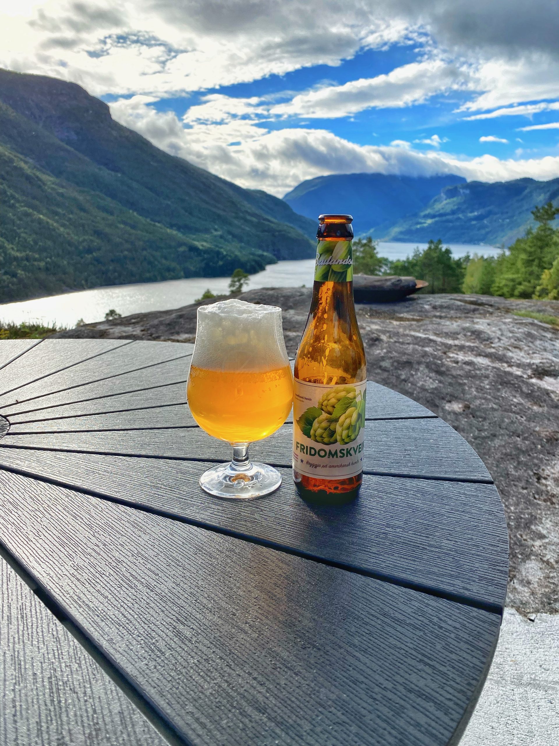 Bottle and glass of Balder Fridomskveik beer on the terrace during a Sogndal Fjordpanorama Review, with fjord and mountain views in Norway