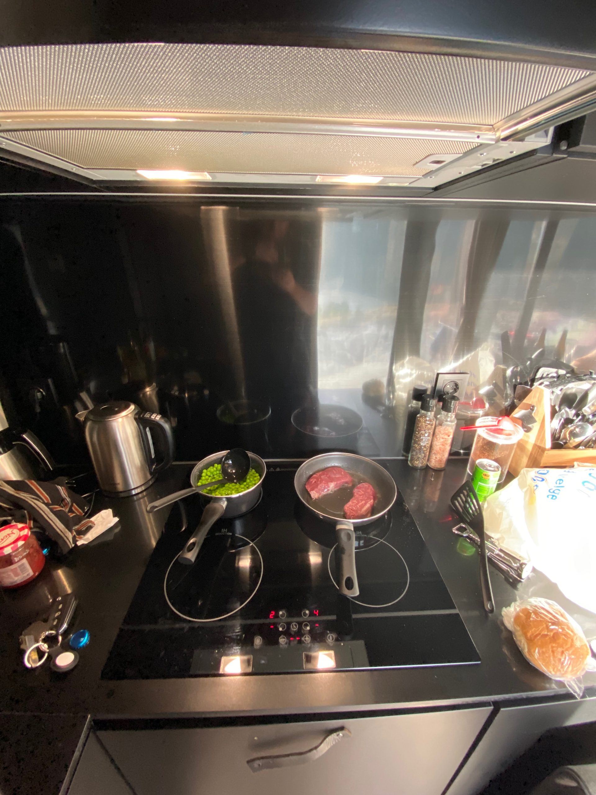 Simple dinner with steak, peas, beer, and bread inside the cabin during a Sogndal Fjordpanorama Review in Norway