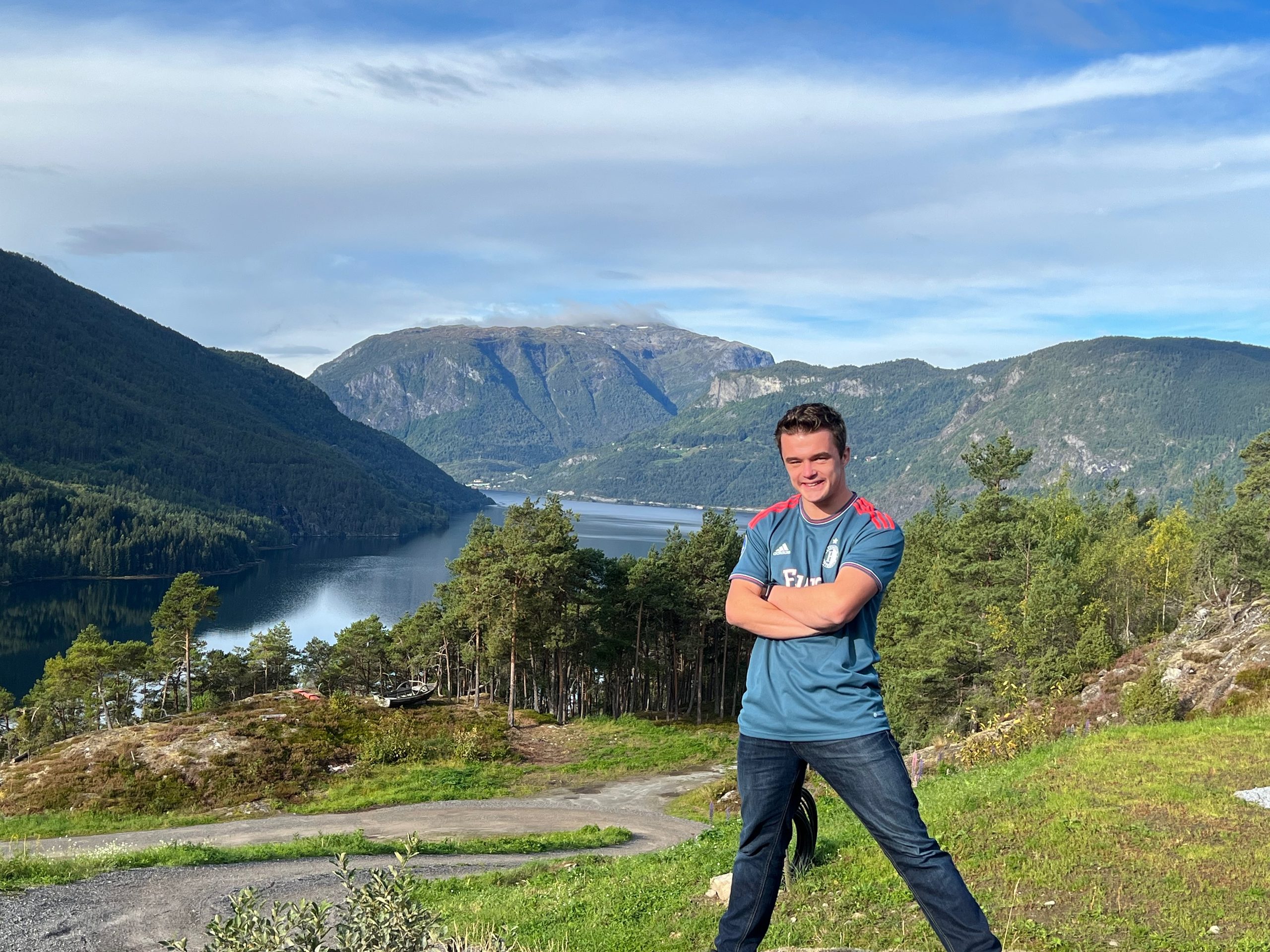 Peter Smit standing at Sogndal Fjordpanorama during a Sogndal Fjordpanorama Review, with fjord, forest, and mountain views in Norway