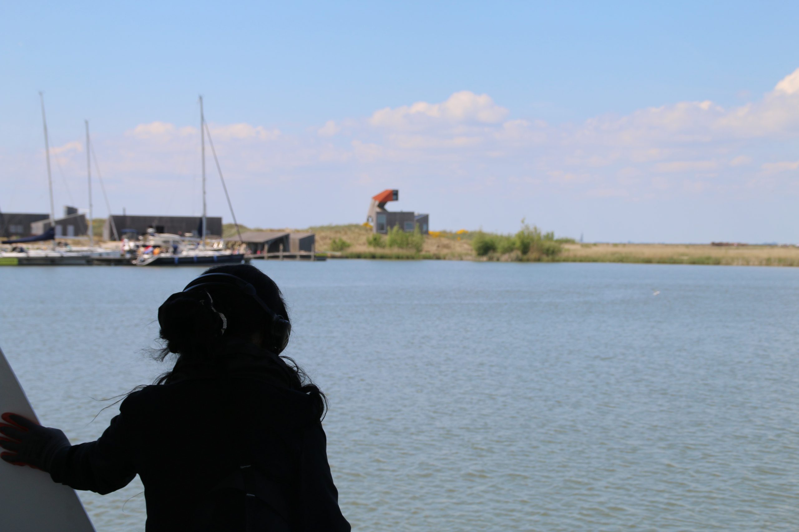 Marker Wadden island visit volunteer on the ferry deck helping with docking as the boat arrives at the island harbor