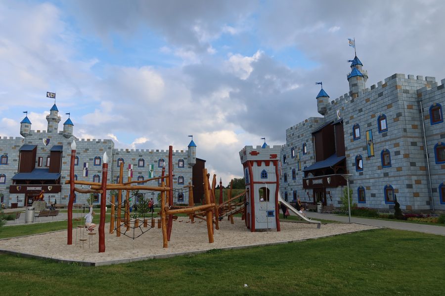 LEGOLAND Castle Hotel IMG 2877 showing the castle themed hotel buildings playground courtyard towers and cloudy sky at LEGOLAND Billund Resort in Denmark